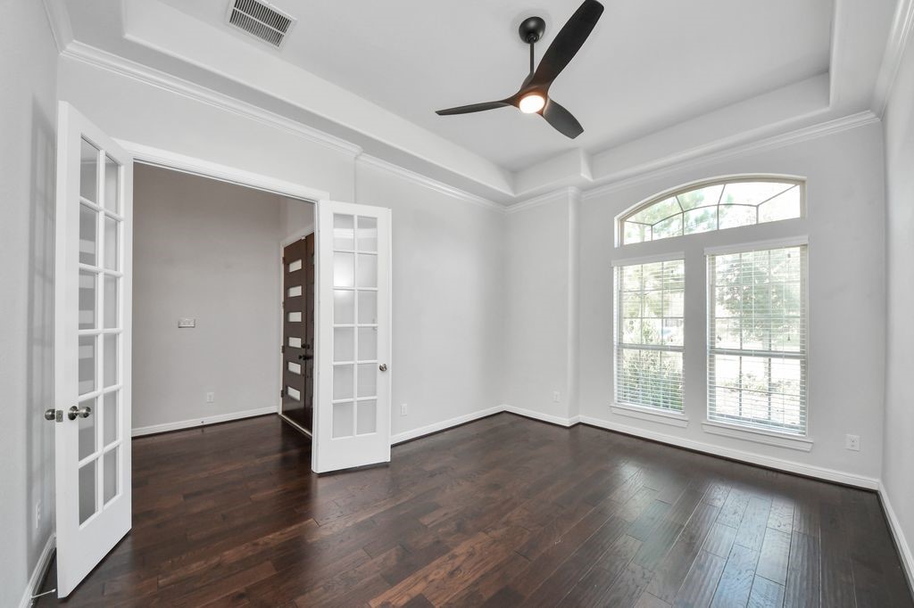 Formal study with French doors and designer ceiling fan.