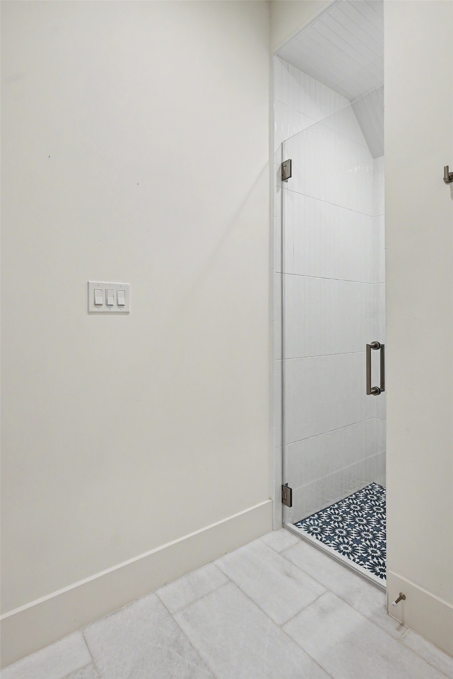 A tiled shower nook completes the secondary bath with a tailored blend of form and function.