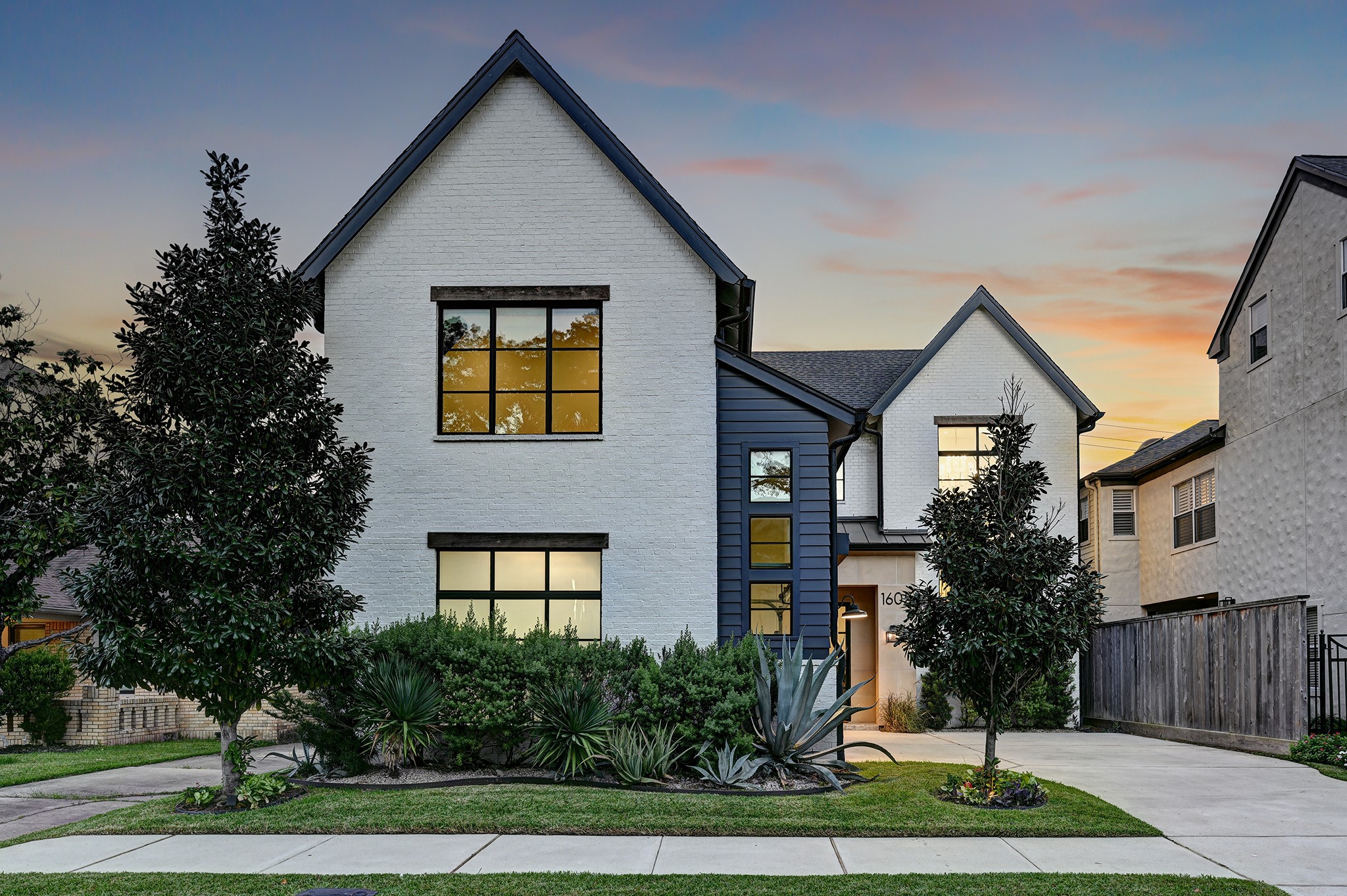 A final exterior view highlights the homes distinctive rooflines, contrasting materials and inviting architectural presence.