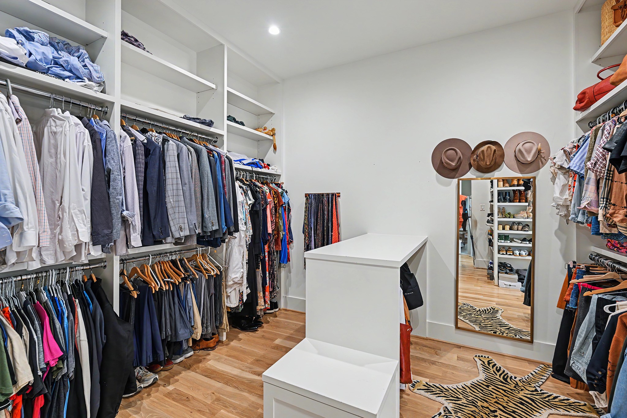 The expansive primary closet offers generous hanging space, custom storage and a central dressing area.