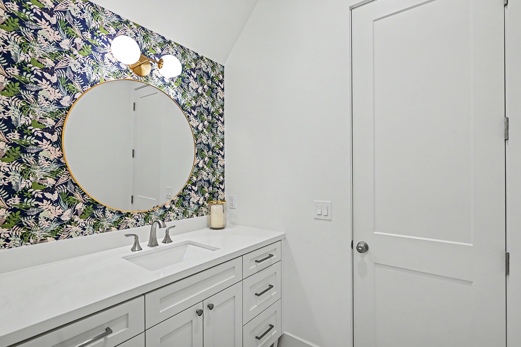 The Hollywood bath with two separate sink vanties complemented by expressive wallcovering and polished designer details.