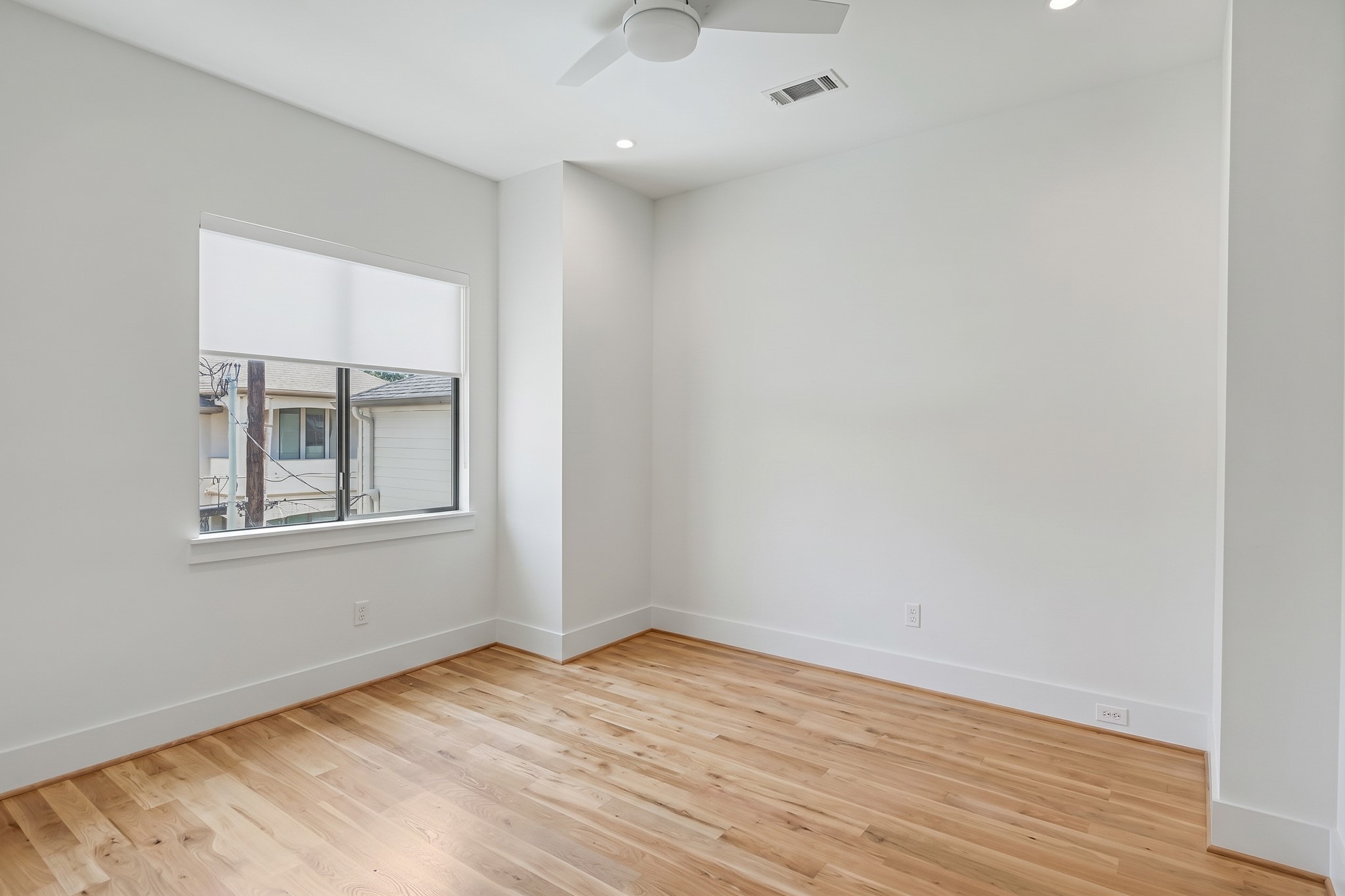An additional secondary bedroom offers white oak flooring, natural light and versatile proportions.