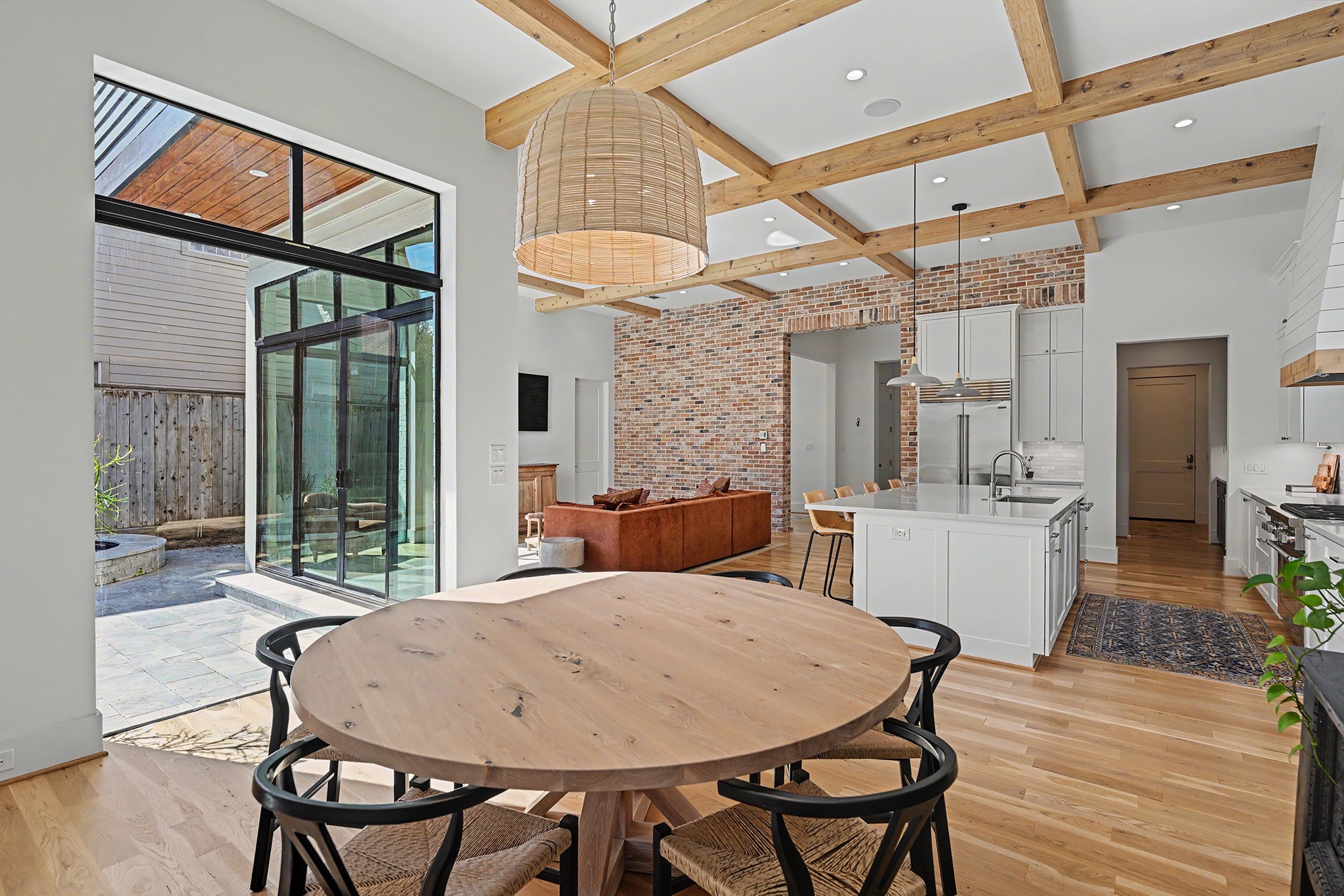 Open sightlines connect the dining room, kitchen and living area while preserving each spaces individual character.