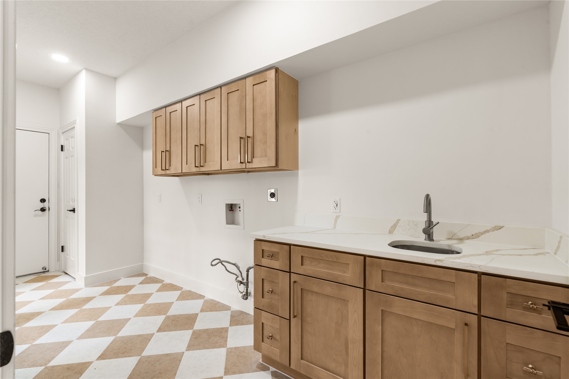 Laundry Room with cabinets and sink