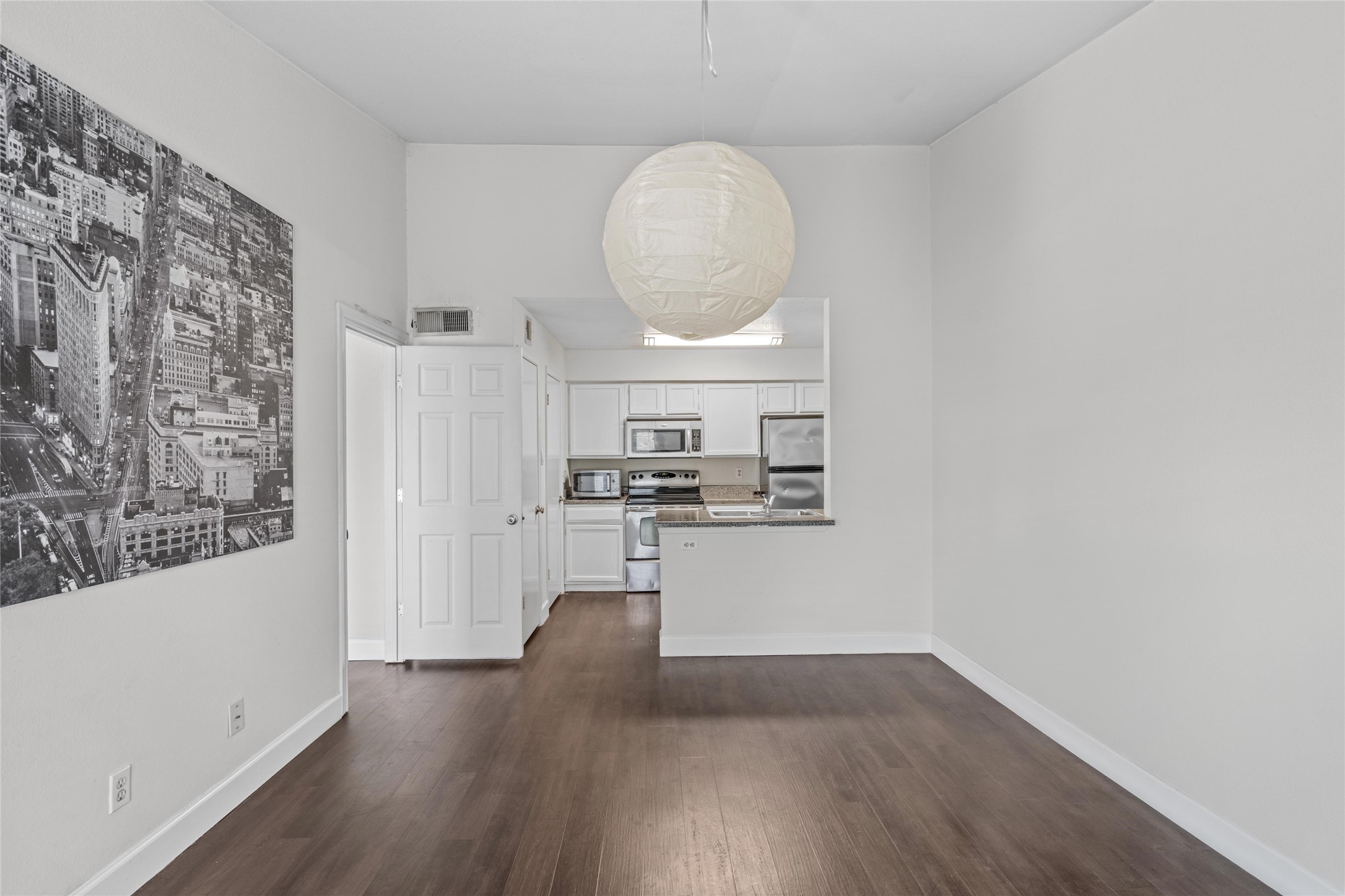 View from the living area highlights the open flow toward the dining and kitchen spaces.