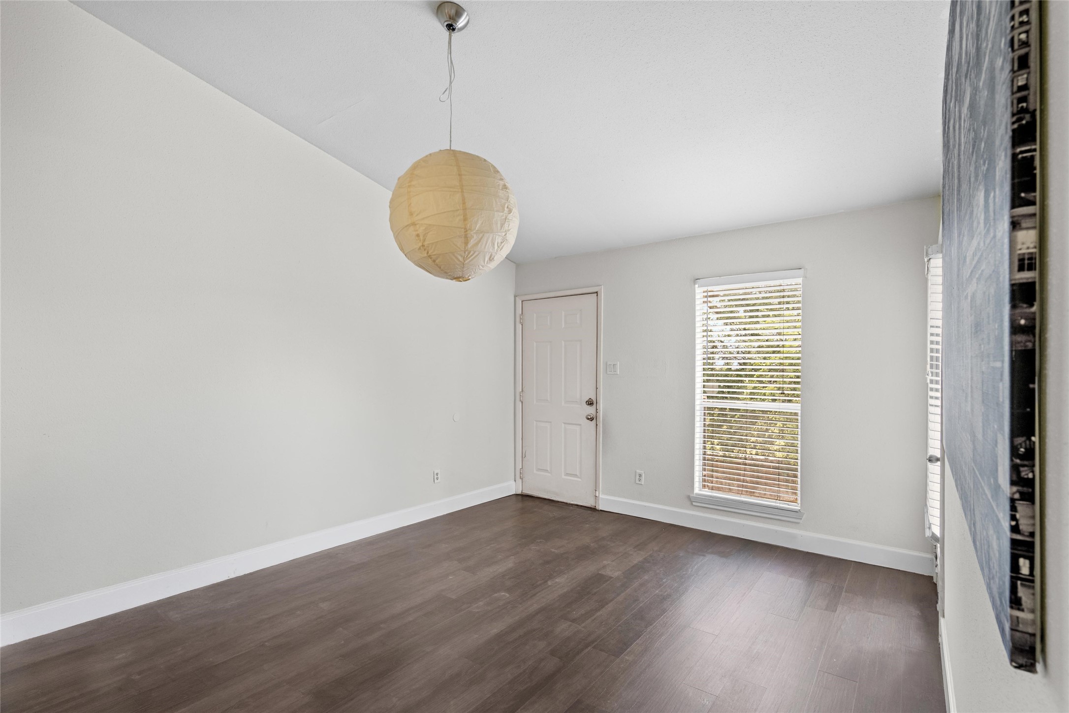Spacious living area features durable flooring, neutral walls, and an open feel with natural light from the nearby window. Spacious living area features durable flooring, neutral walls, and an open feel with natural light from the nearby window.