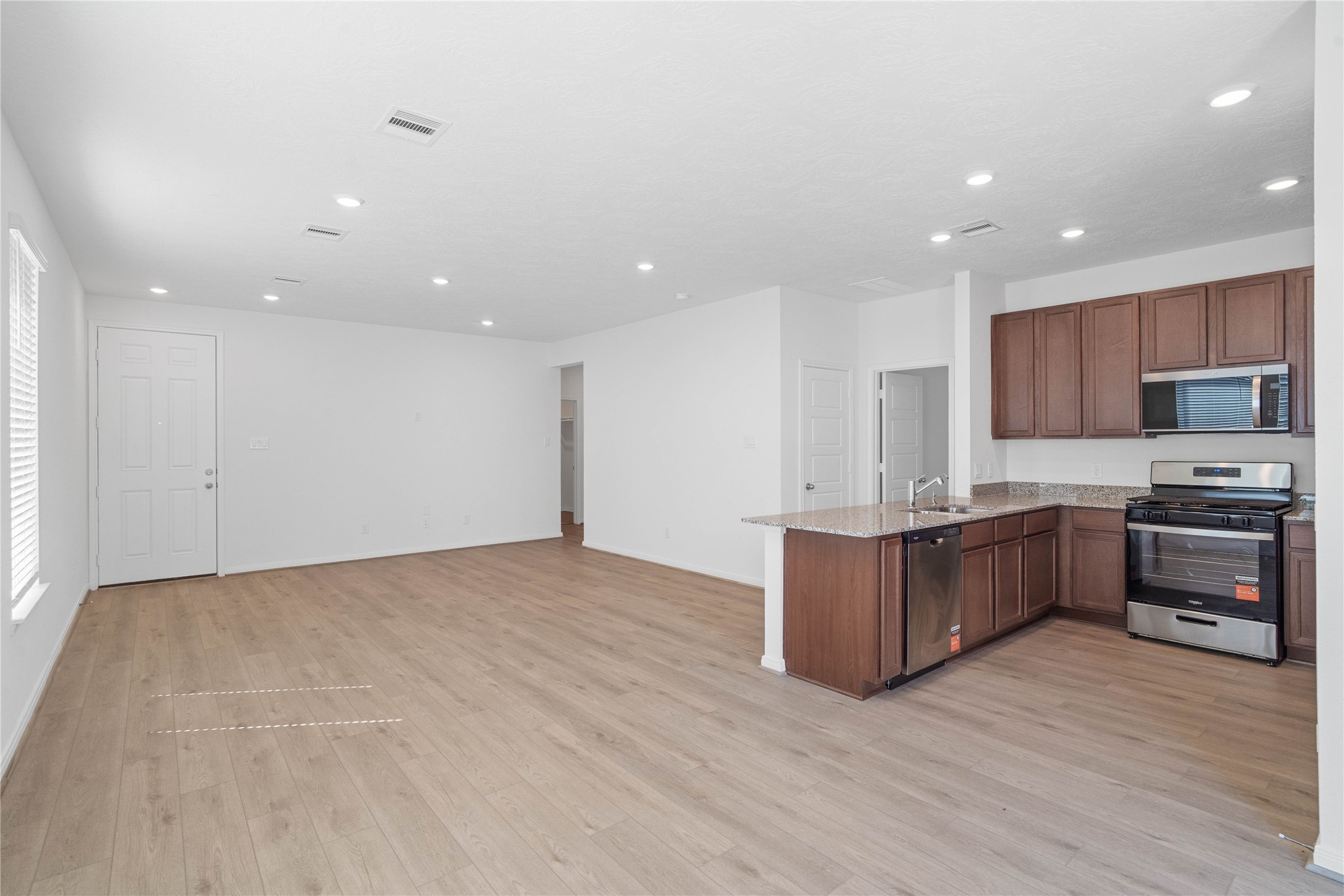 Stunning open-concept design seamlessly connecting the living, dining, and kitchen areasperfect for both everyday living and entertaining!