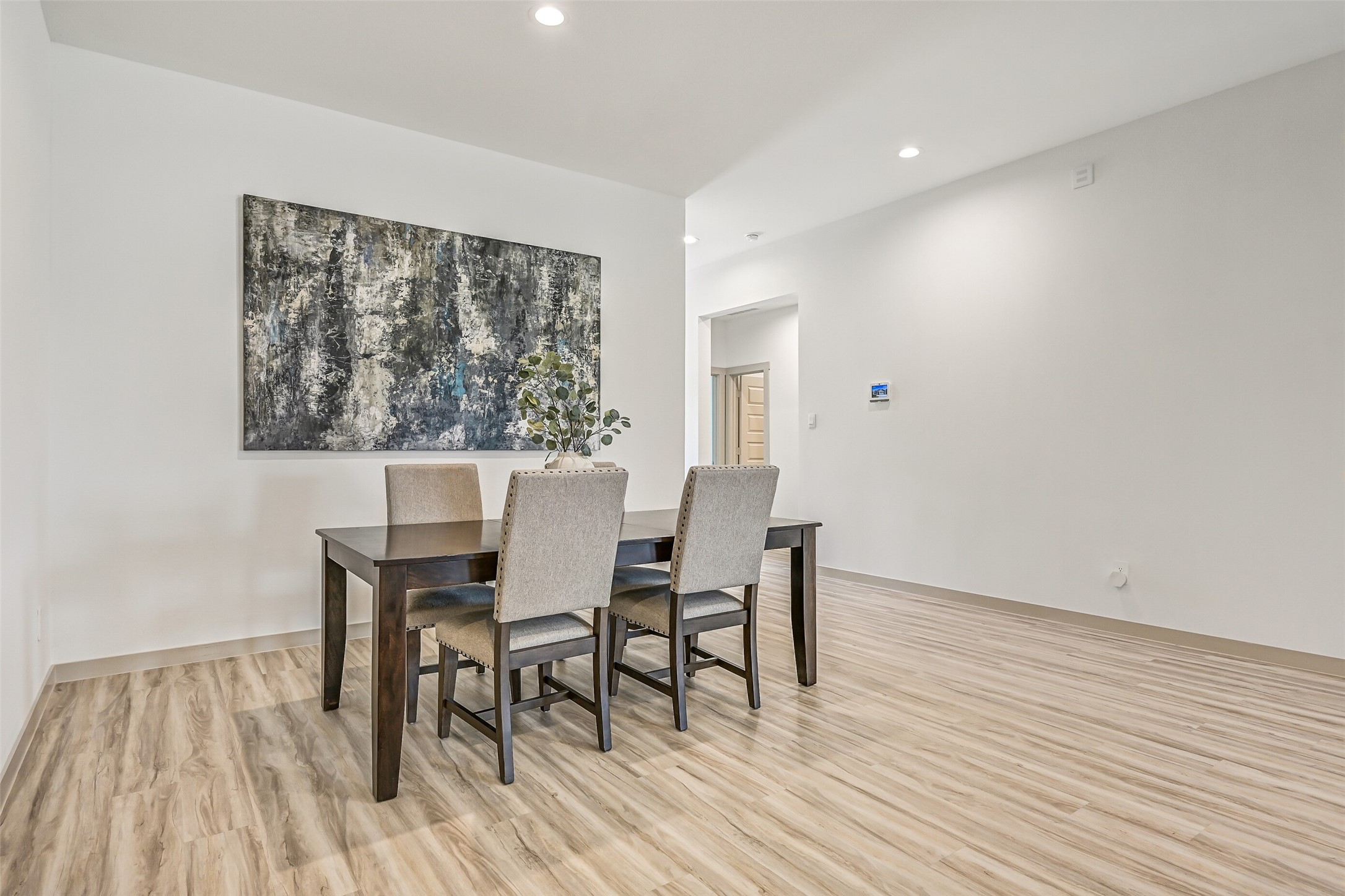 Spacious and open to the adjoining kitchen, the dining area offers plenty of room for a large table while maintaining an easy connection to the home's main gathering spaces.