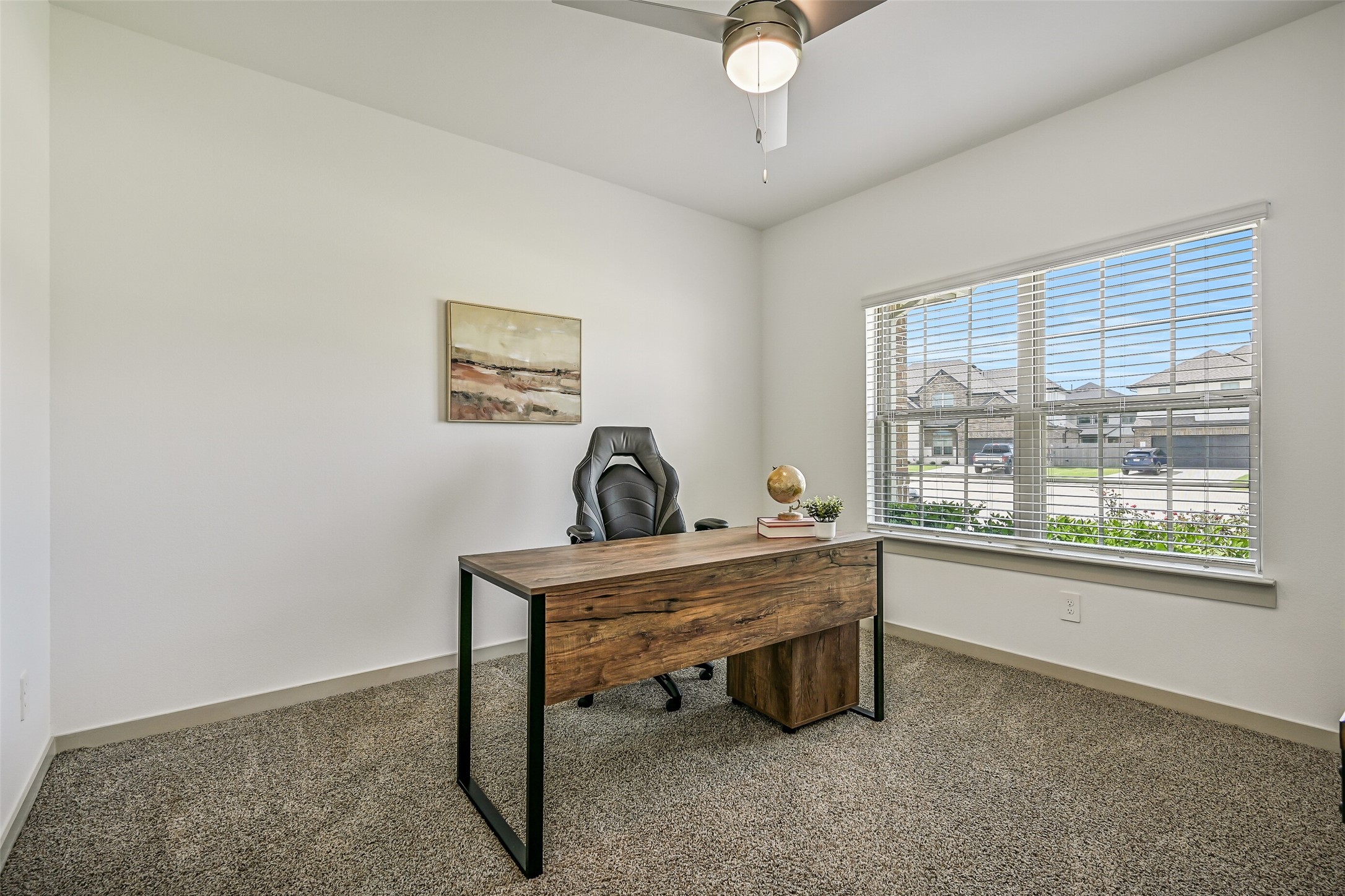 Positioned at the front of the home, this versatile bedroom offers a large window, ceiling fan and generous proportions, making it equally well suited for use as a private home office or study.