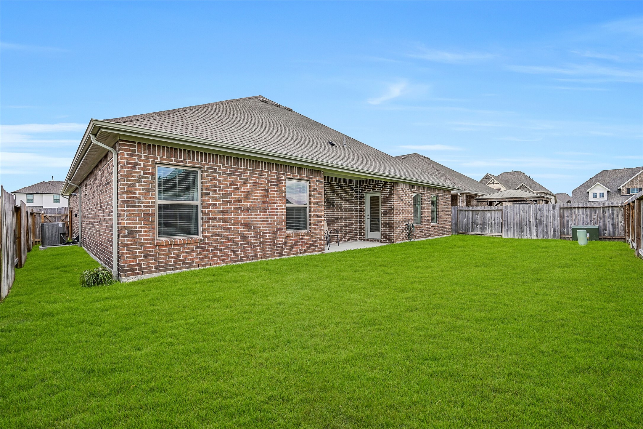 The generously sized fenced backyard provides a broad expanse of level lawn with plenty of room for outdoor recreation, pets, gardening or creating your own personalized backyard retreat.