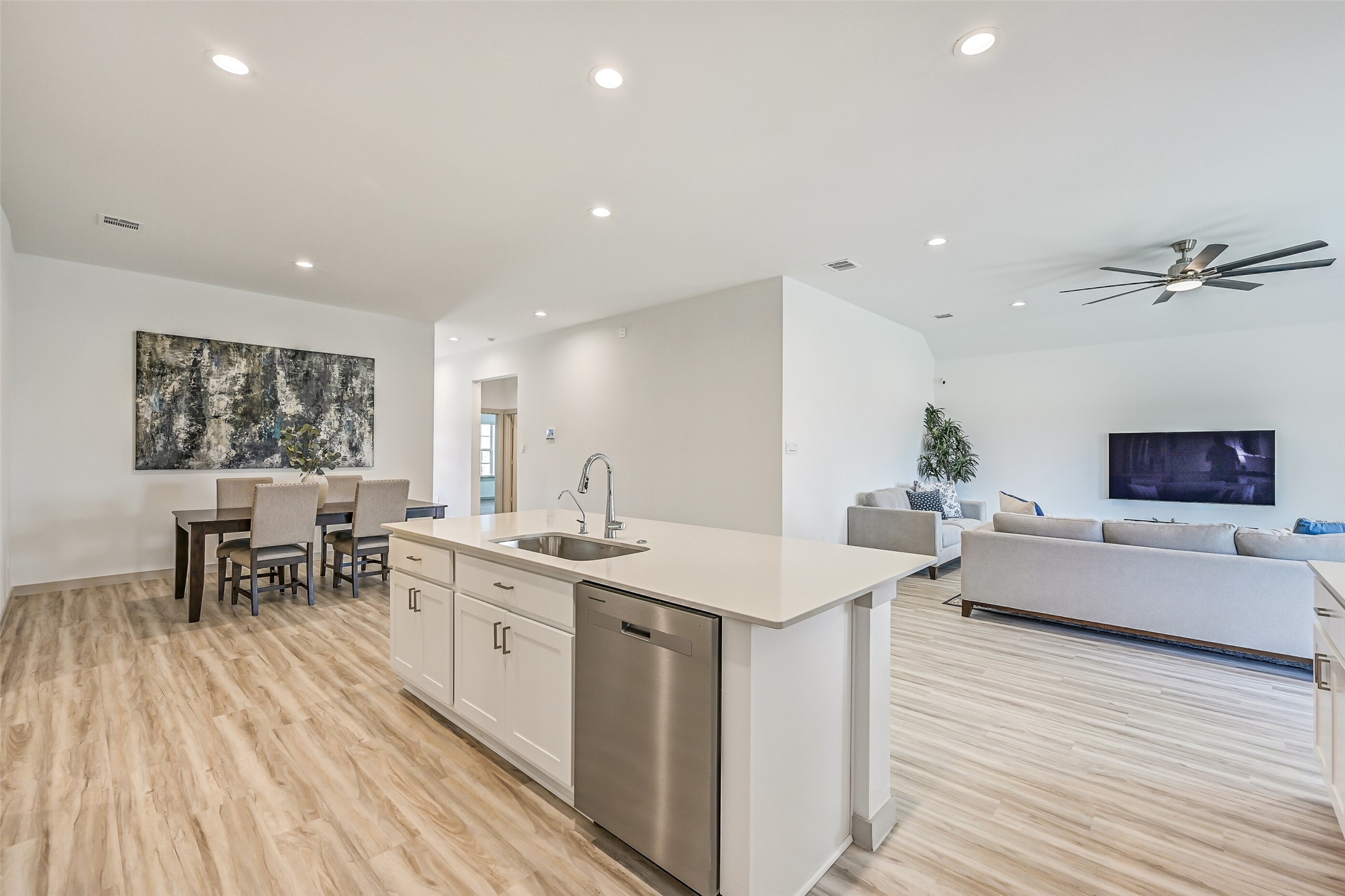 This angle really showcases the home's open design, with the island kitchen positioned between the spacious dining and family rooms for effortless flow from one living space to the next.