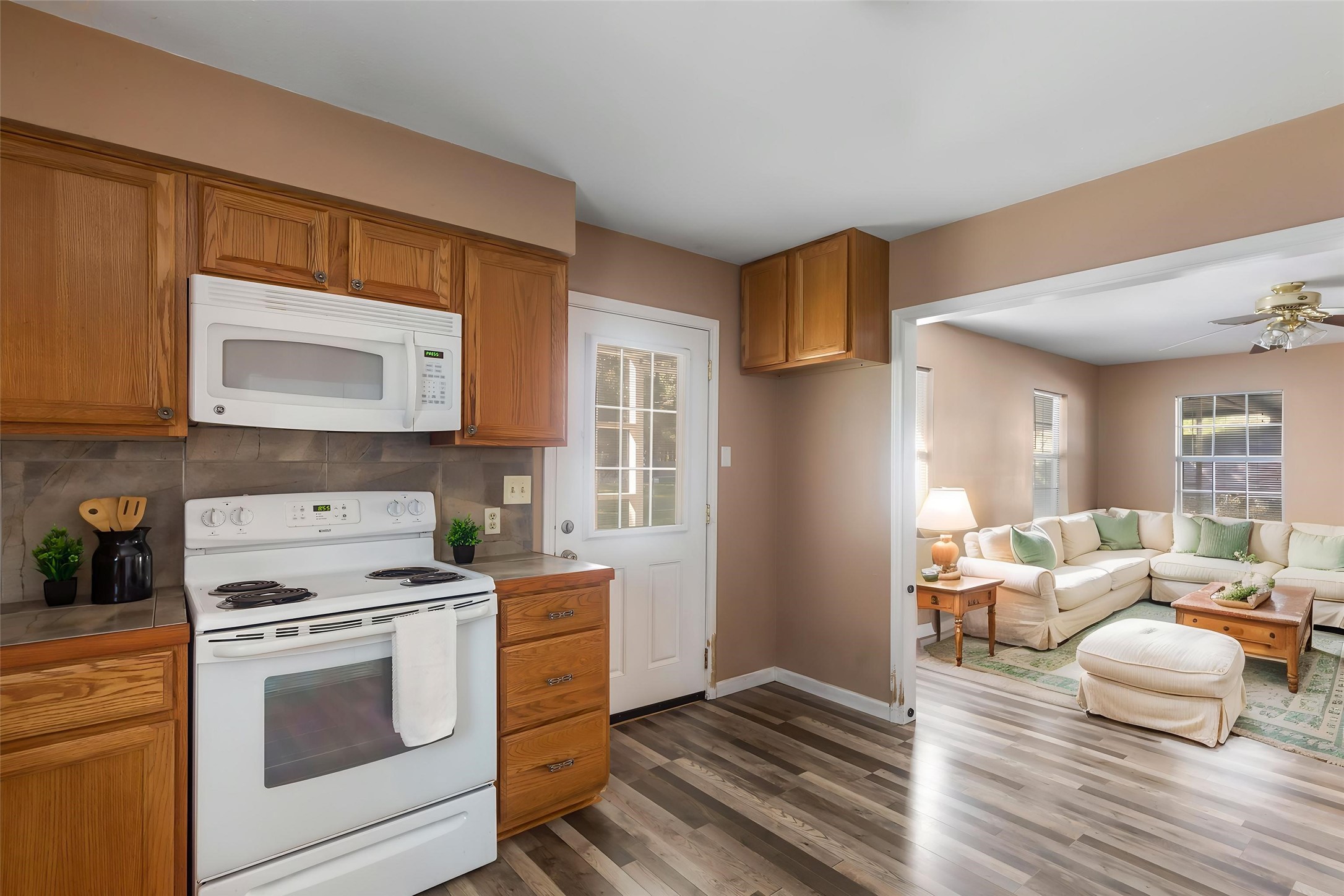 Convenient kitchen layout with easy access to the living area and exterior door. (This photo is virtually staged.)