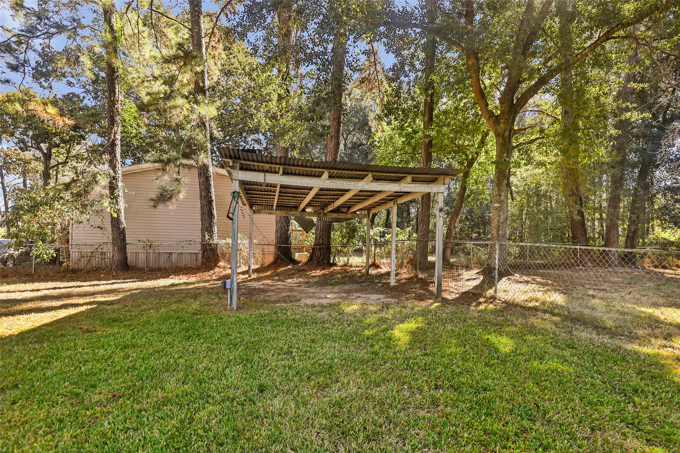 Additional carport can be used for car, boat or mower storage.