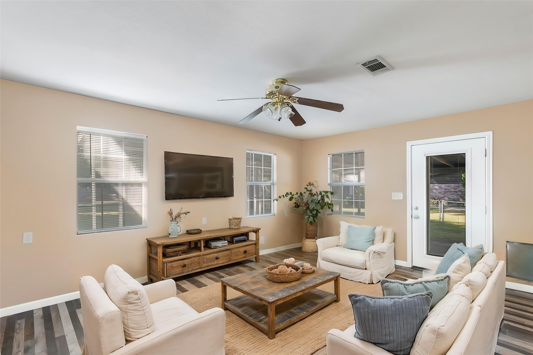 Additional view of the living area with windows and exterior access. (This photo is virtually staged.)