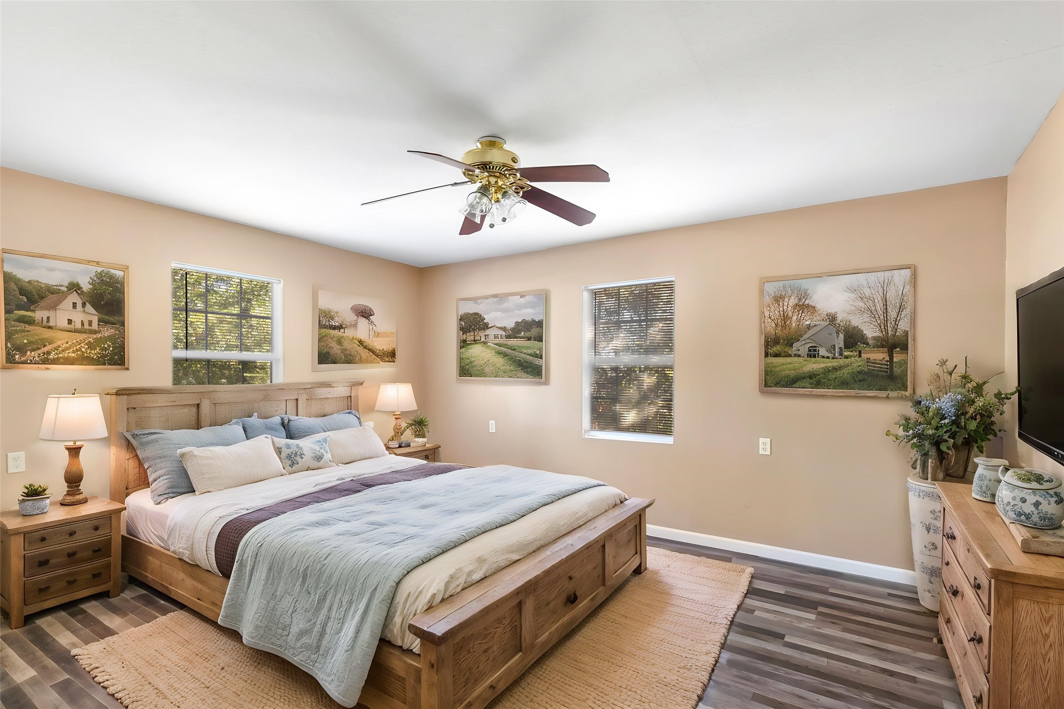 Primary bedroom features a walk-in closet, natural light and a ceiling fan. (This photo is virtually staged.)