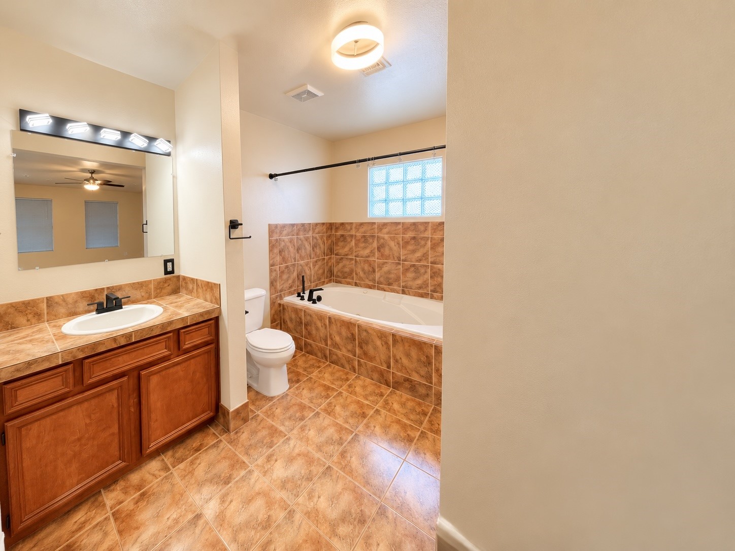 Primary bathroom with jacuzzi tub to relax.