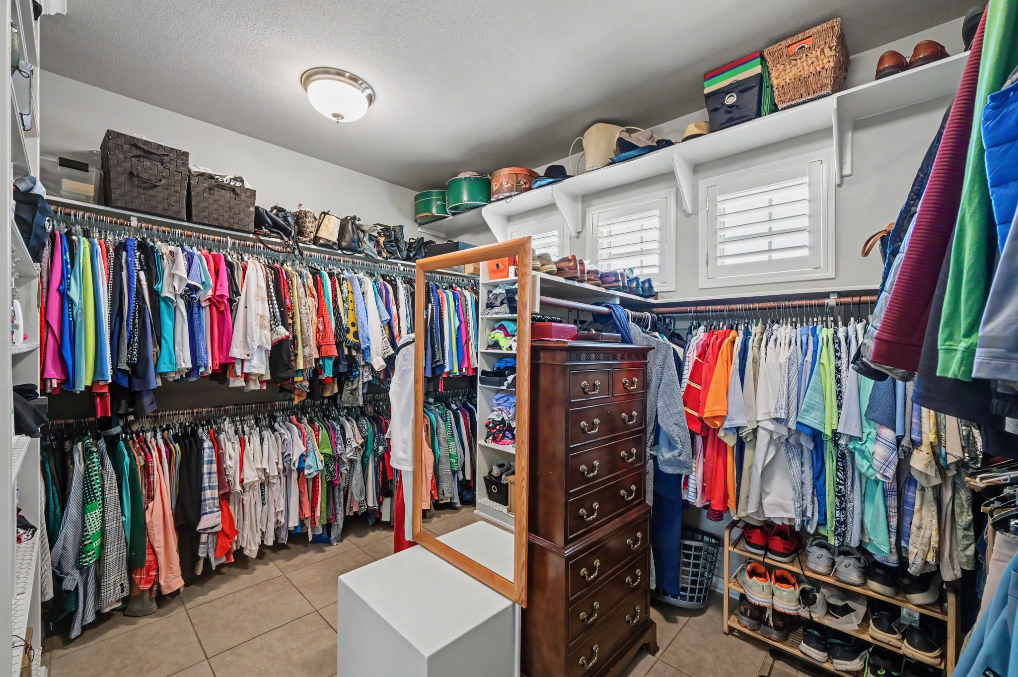 Exceptional walk-in closet with abundant hanging space and custom storage.