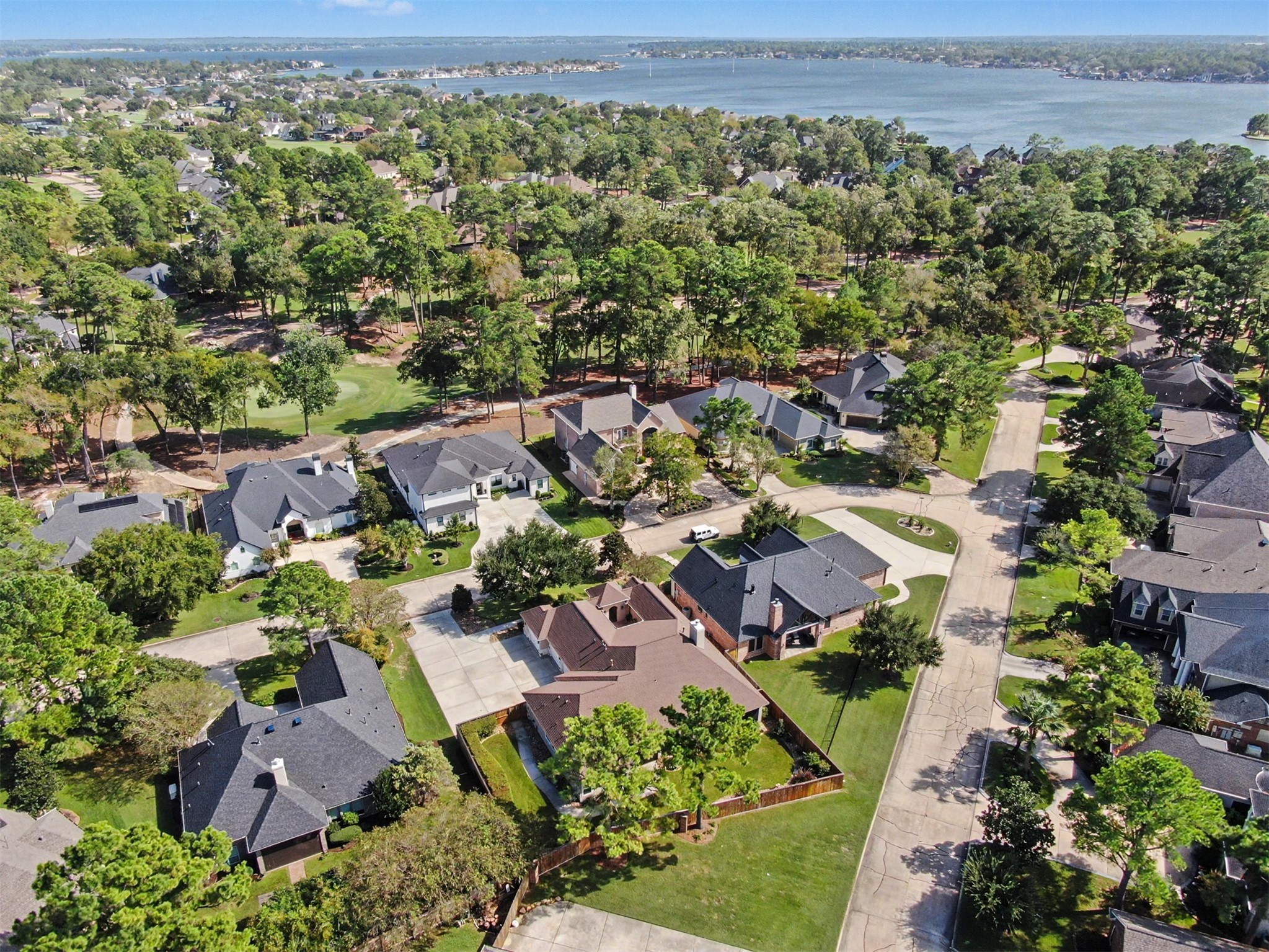 Picturesque aerial view of Bentwater's beautiful neighborhood with Lake Conroe beyond.
