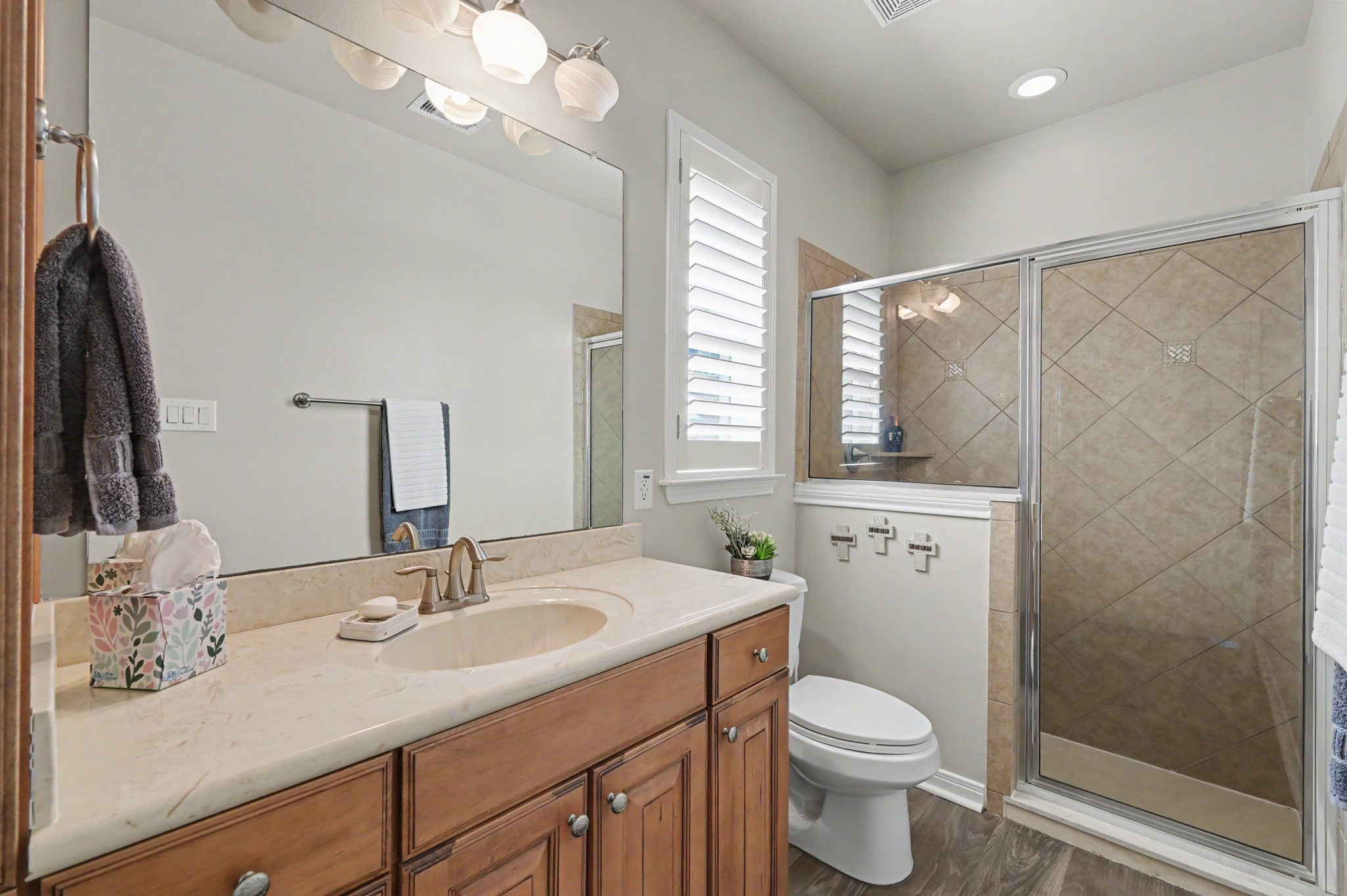 Private casita bathroom with spacious vanity and beautifully tiled walk-in shower.