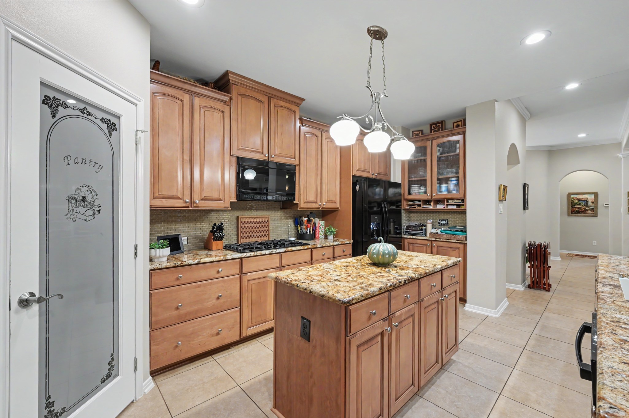 Well-appointed kitchen featuring abundant storage, center island, and gas cooktop.