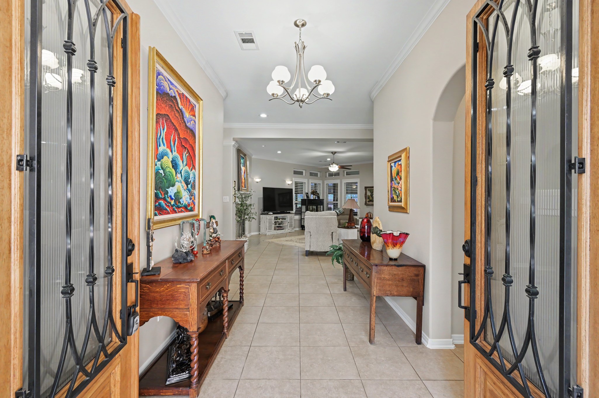 Gracious entry foyer with decorative iron doors and an inviting open layout.