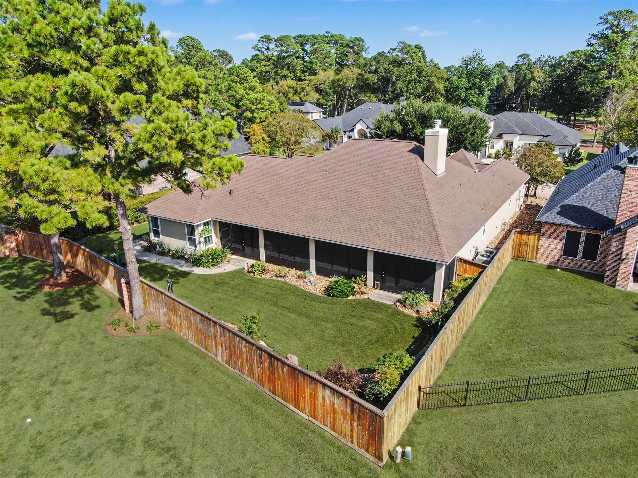 Spectacular aerial perspective of the expansive screened porch and private backyard.