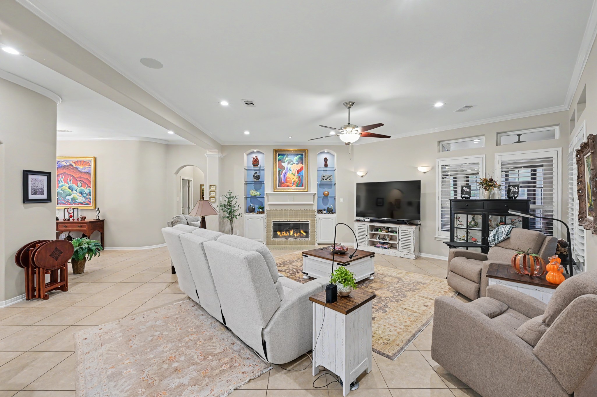 Spacious family room with elegant finishes, custom cabinetry, and cozy fireplace.