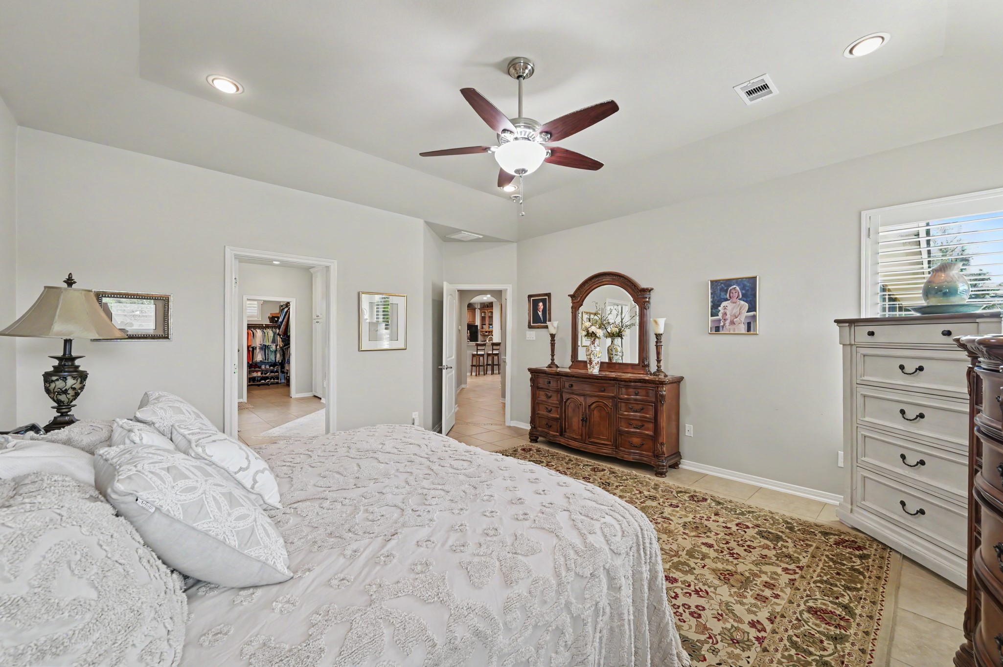 Generously sized primary suite with tray ceiling and timeless architectural details.