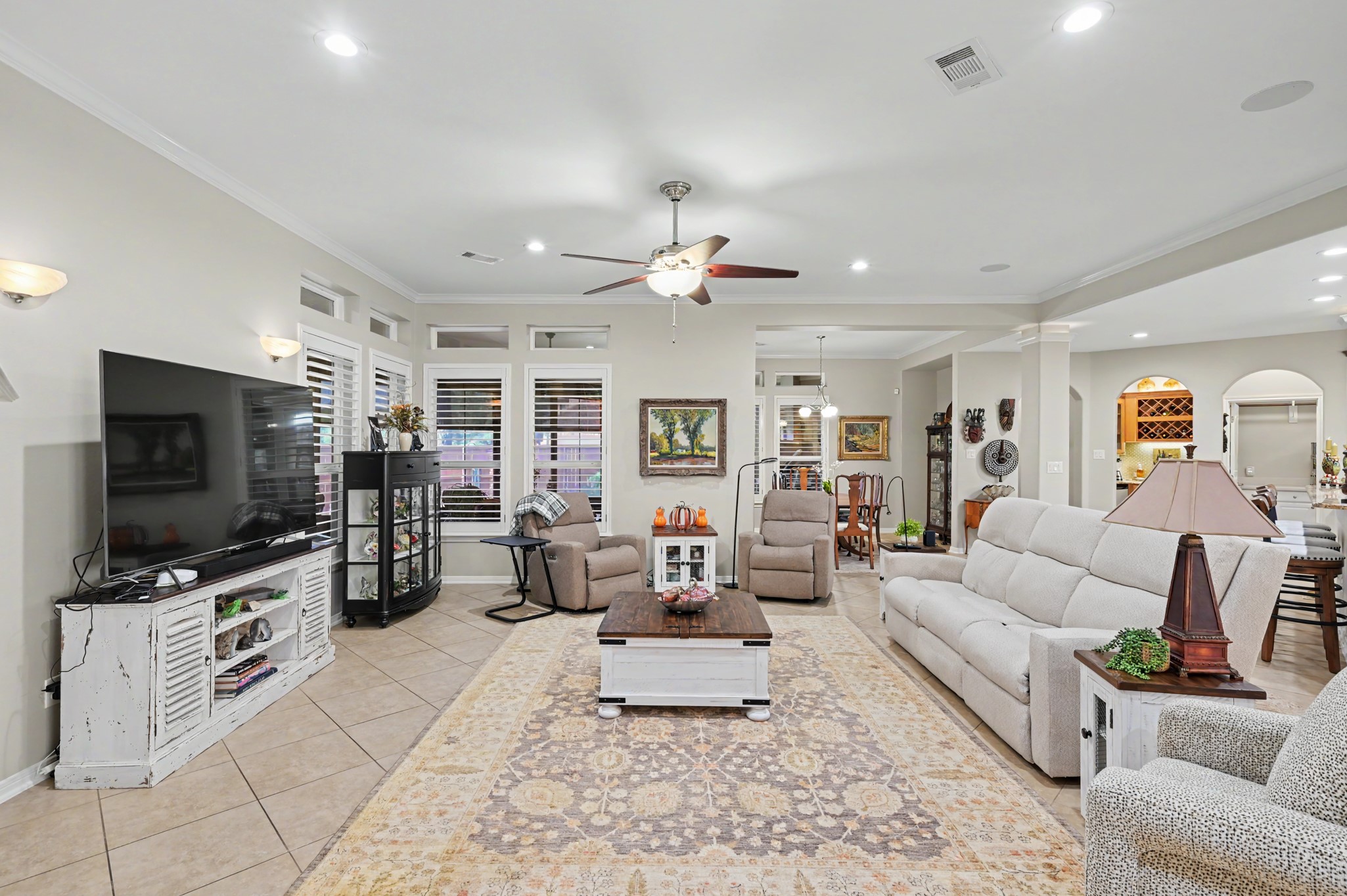 Bright, inviting family room featuring beautiful built-ins and abundant natural light.