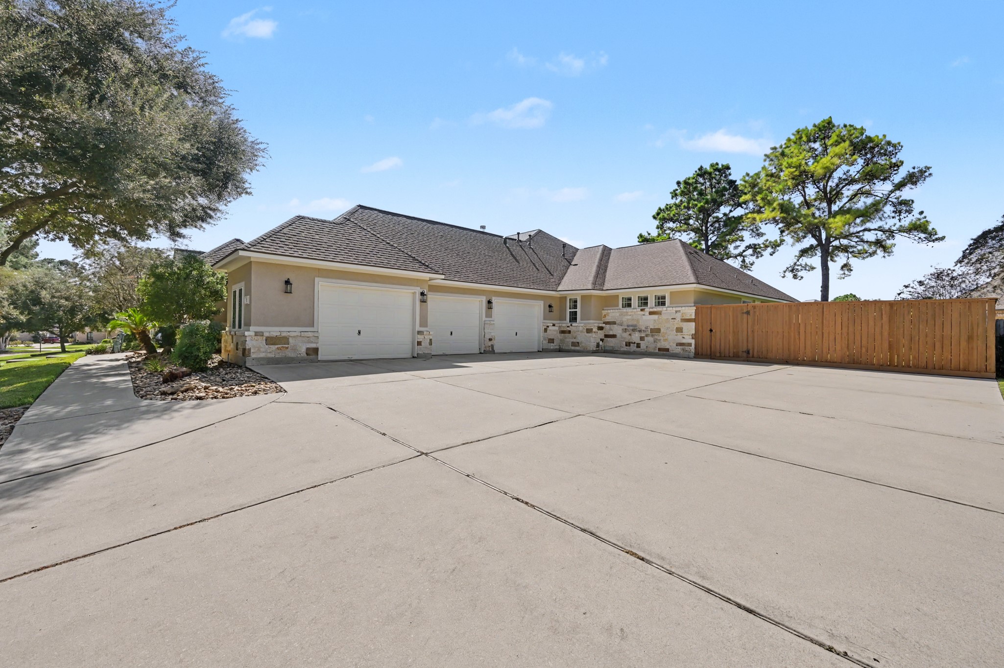 Expansive driveway and attached garage offering exceptional parking convenience.
