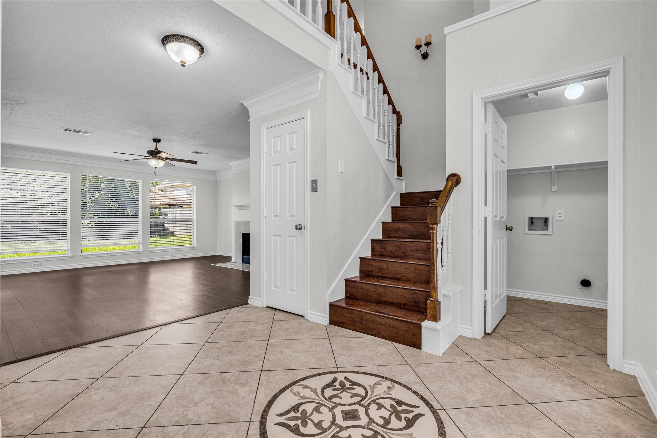 The entry connects to the staircase, living room and a convenient utility room.