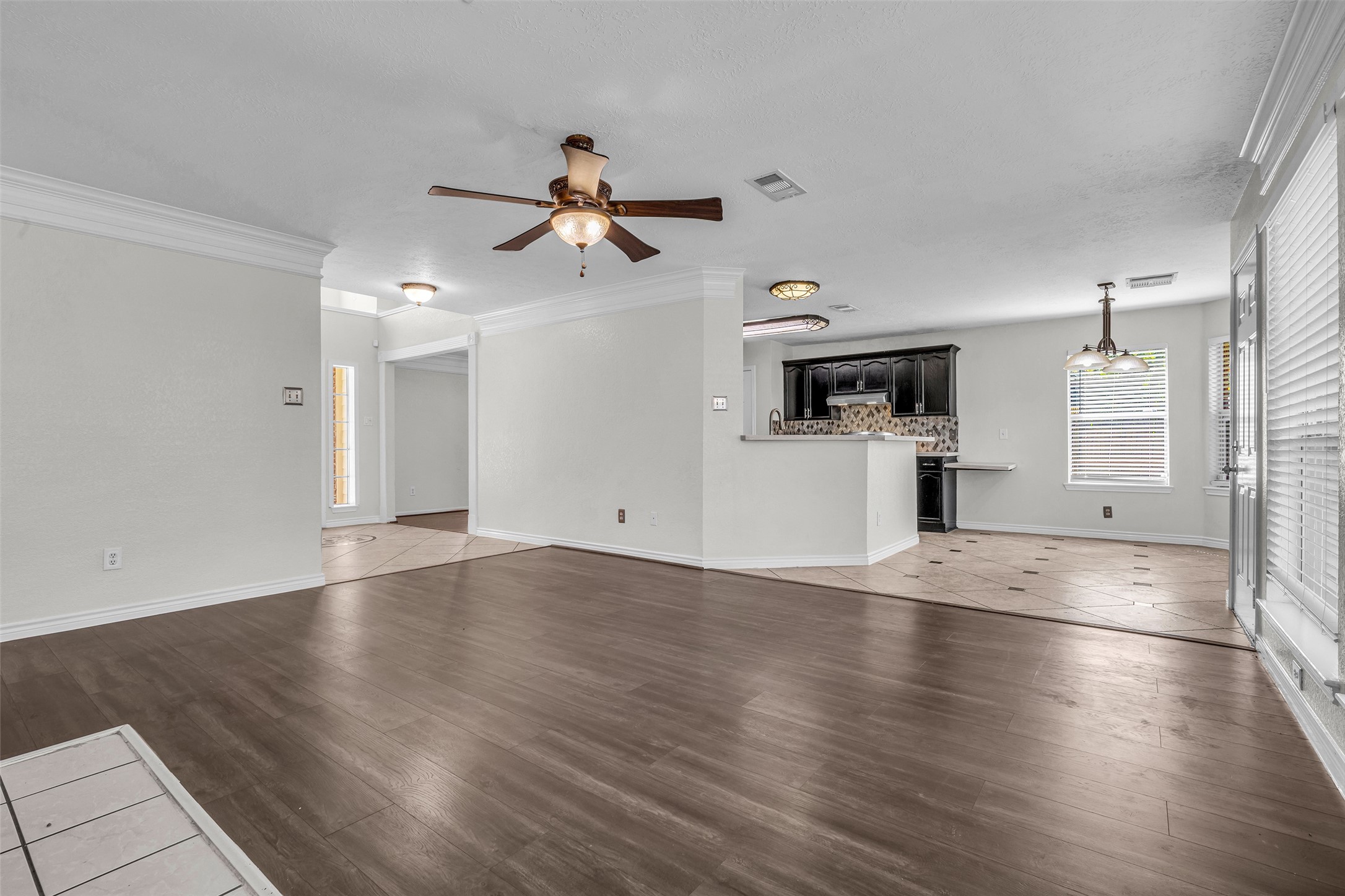 Open sightlines from the living room to the kitchen and breakfast area keep everyone connected.