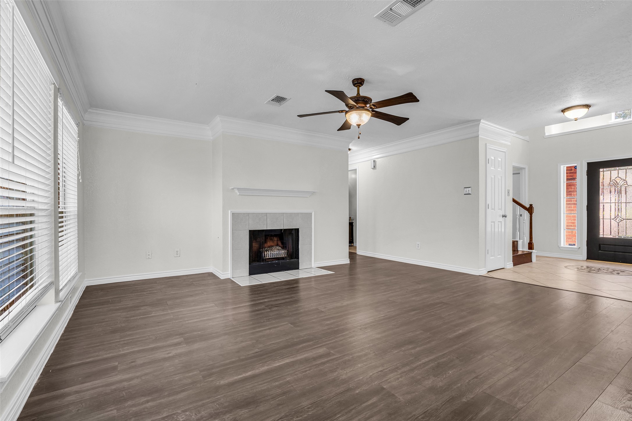 A spacious gathering area that flows back toward the entry and staircase.