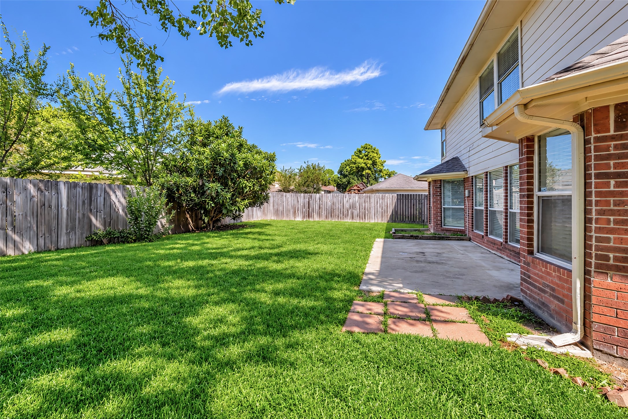 A side patio and privacy fencing for easy outdoor living.