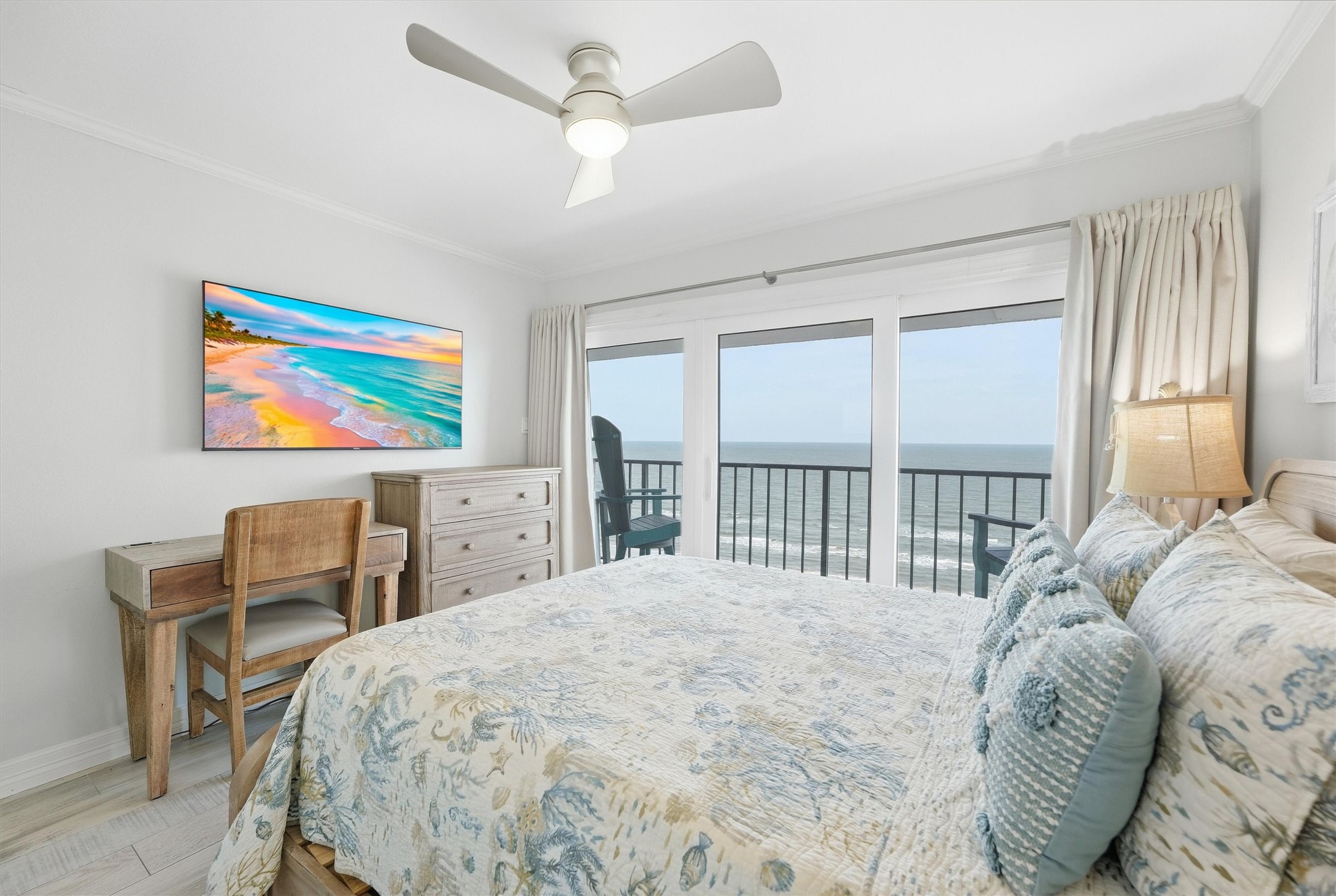 Bright and airy bedroom with ocean views, featuring a cozy bed, stylish decor, and a private balcony for seaside relaxation.