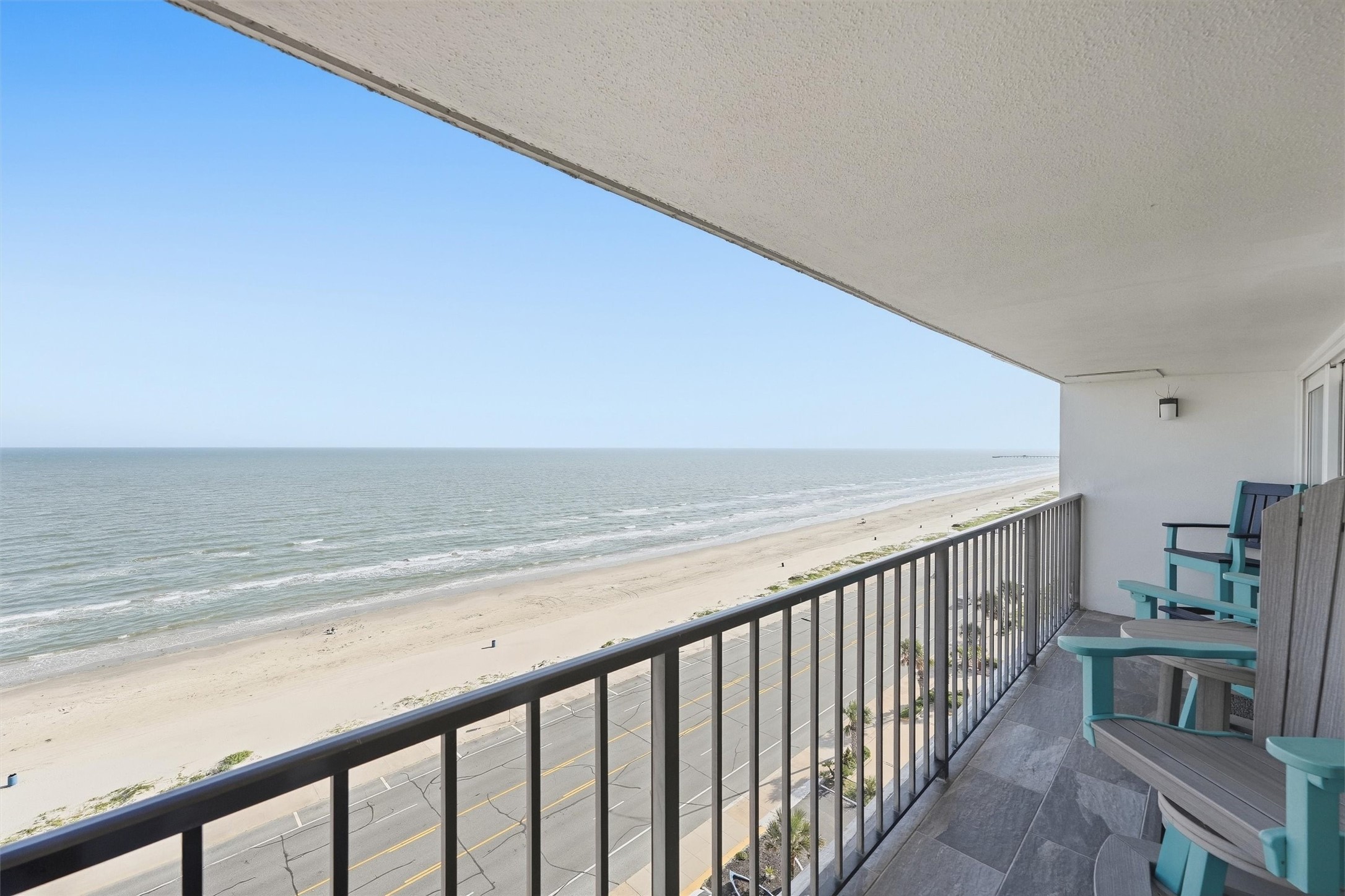 Experience breathtaking ocean views from this spacious balcony, perfect for relaxing and enjoying the serene beachfront setting.