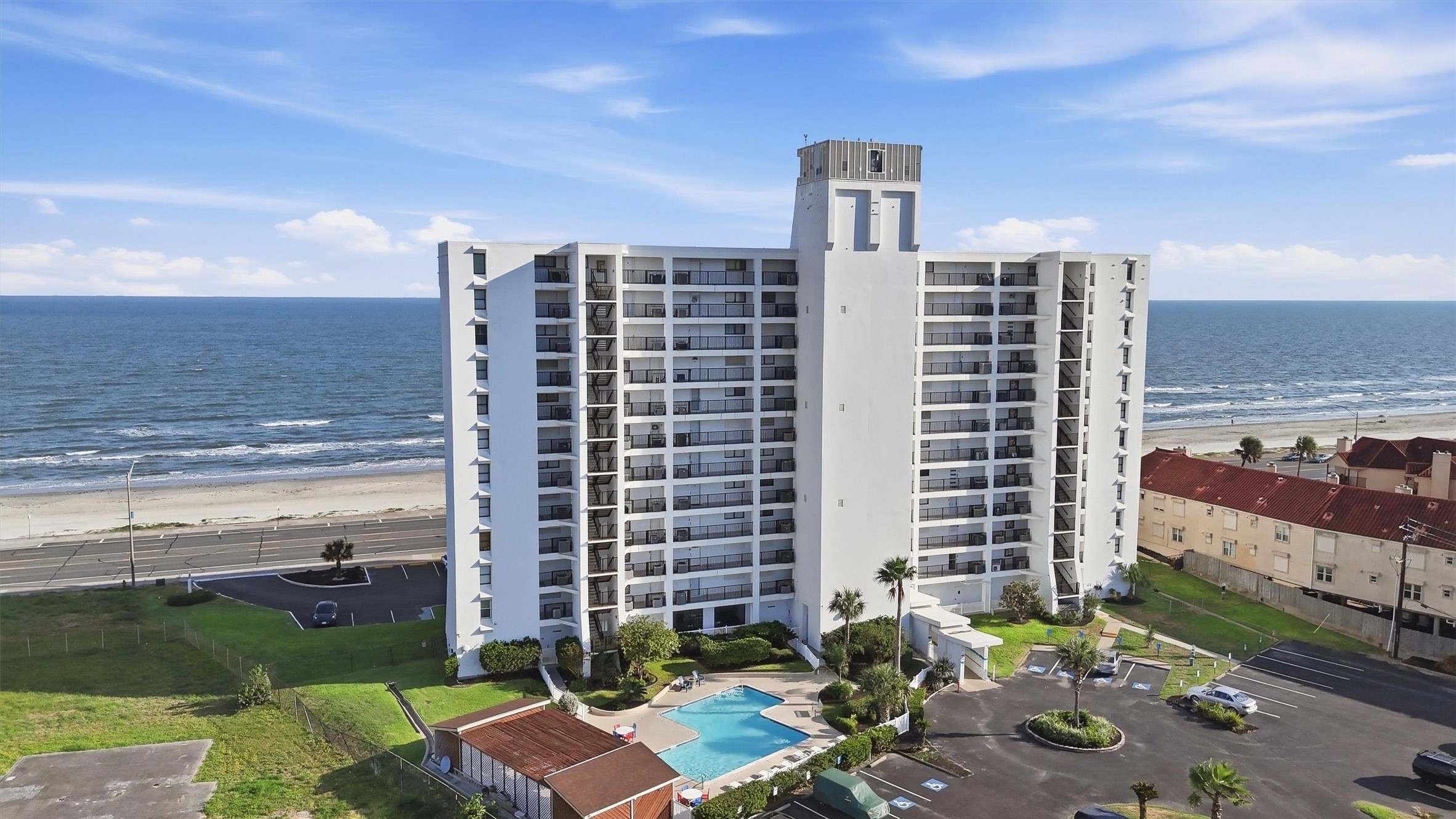 Discover coastal living in this modern beachfront condominium featuring stunning ocean views, a sparkling pool, and easy beach access. Perfect for those seeking a serene seaside retreat.