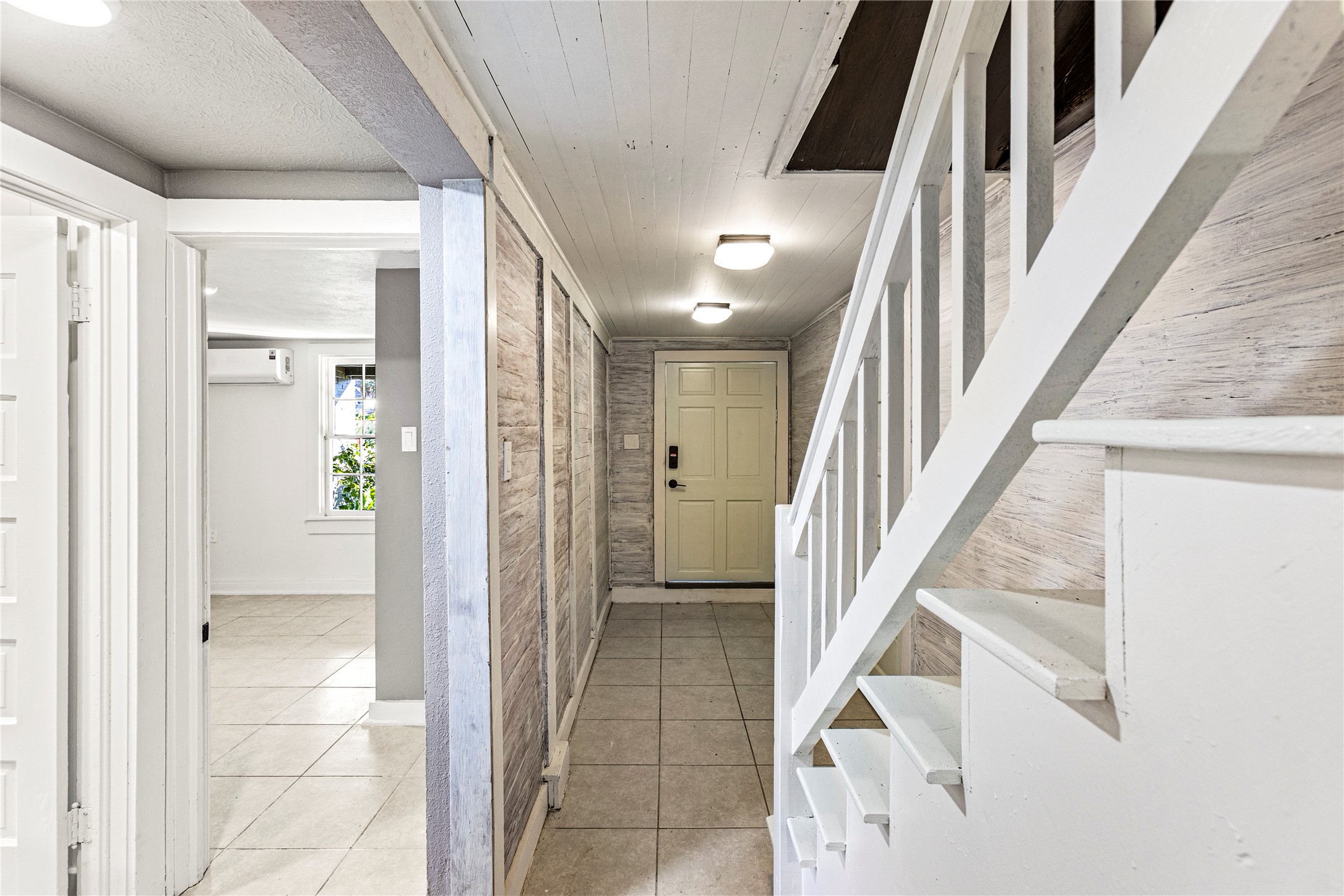 Hallway leading to smaller bedroom and utility area