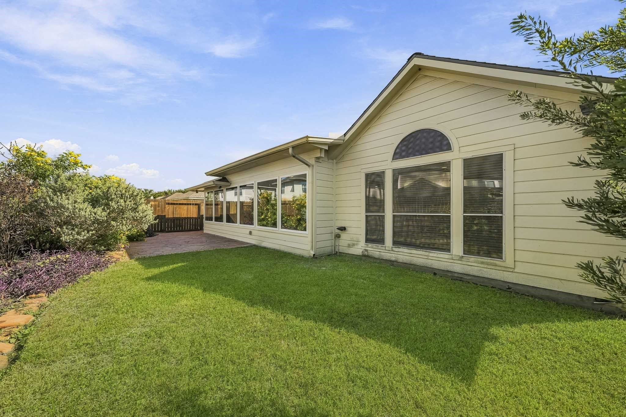 Beyond the patio, you will find expansive, open yard space that provides endless possibilities for your outdoor enjoyment, whether you are hosting weekend summer gatherings, setting up a play area, or simply relaxing in your own private, green oasis. This outdoor area is designed for both peaceful relaxation and vibrant entertaining, seamlessly blending natural beauty with functional space for your lifestyle needs.