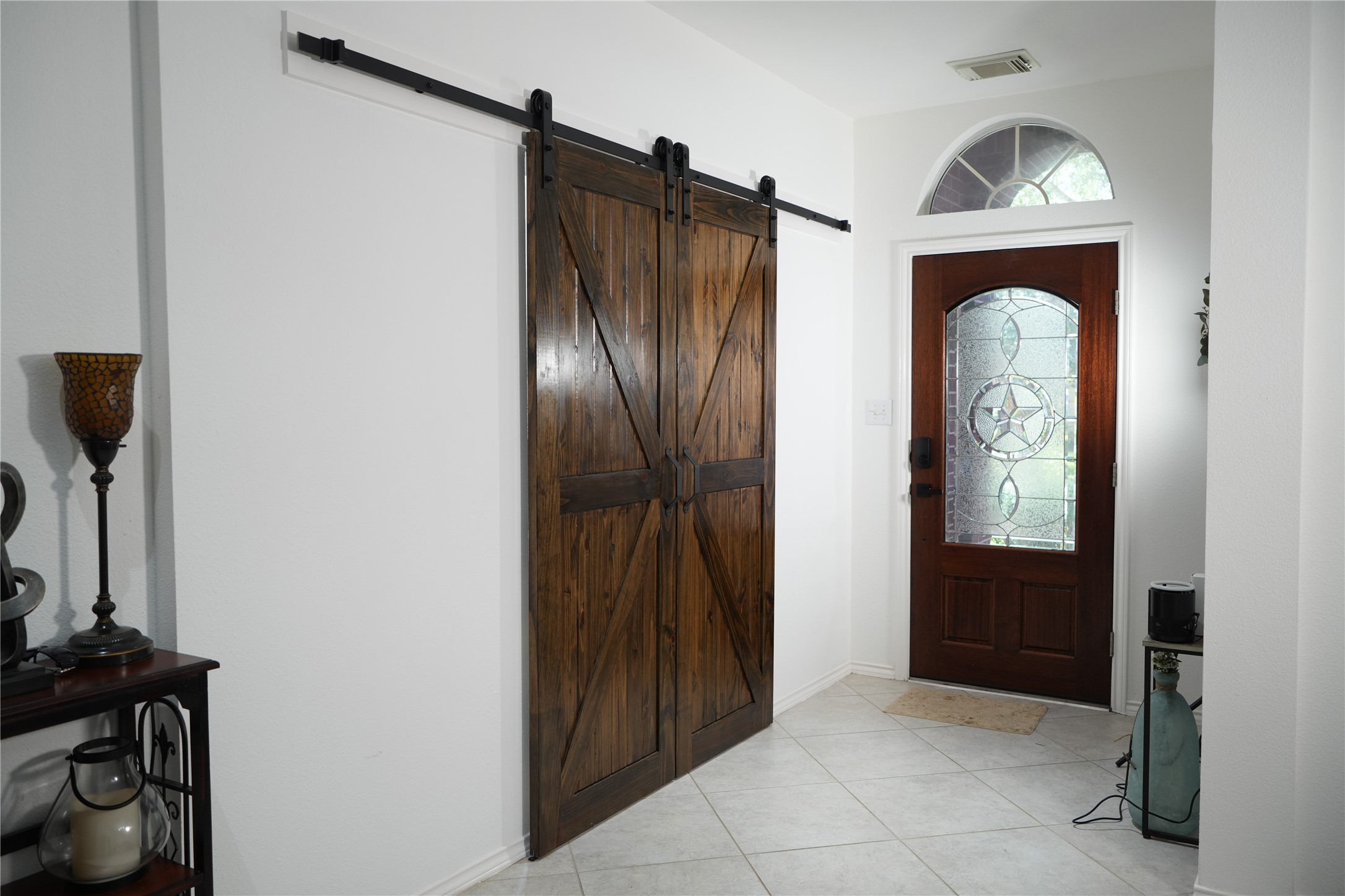 Entrance of the home. Sliding barn doors leading into the study.