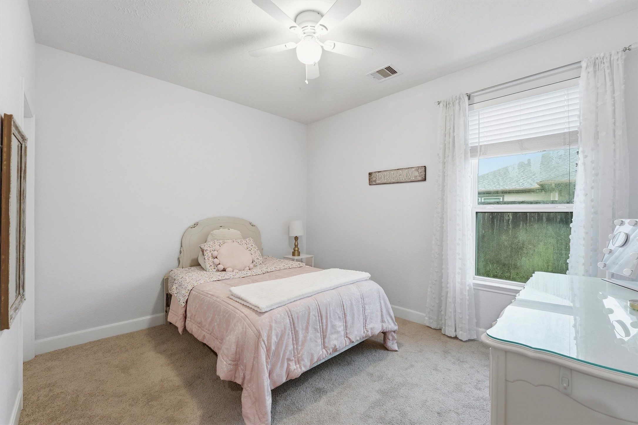 Additional secondary bedroom with soft carpet and beautiful natural light.
