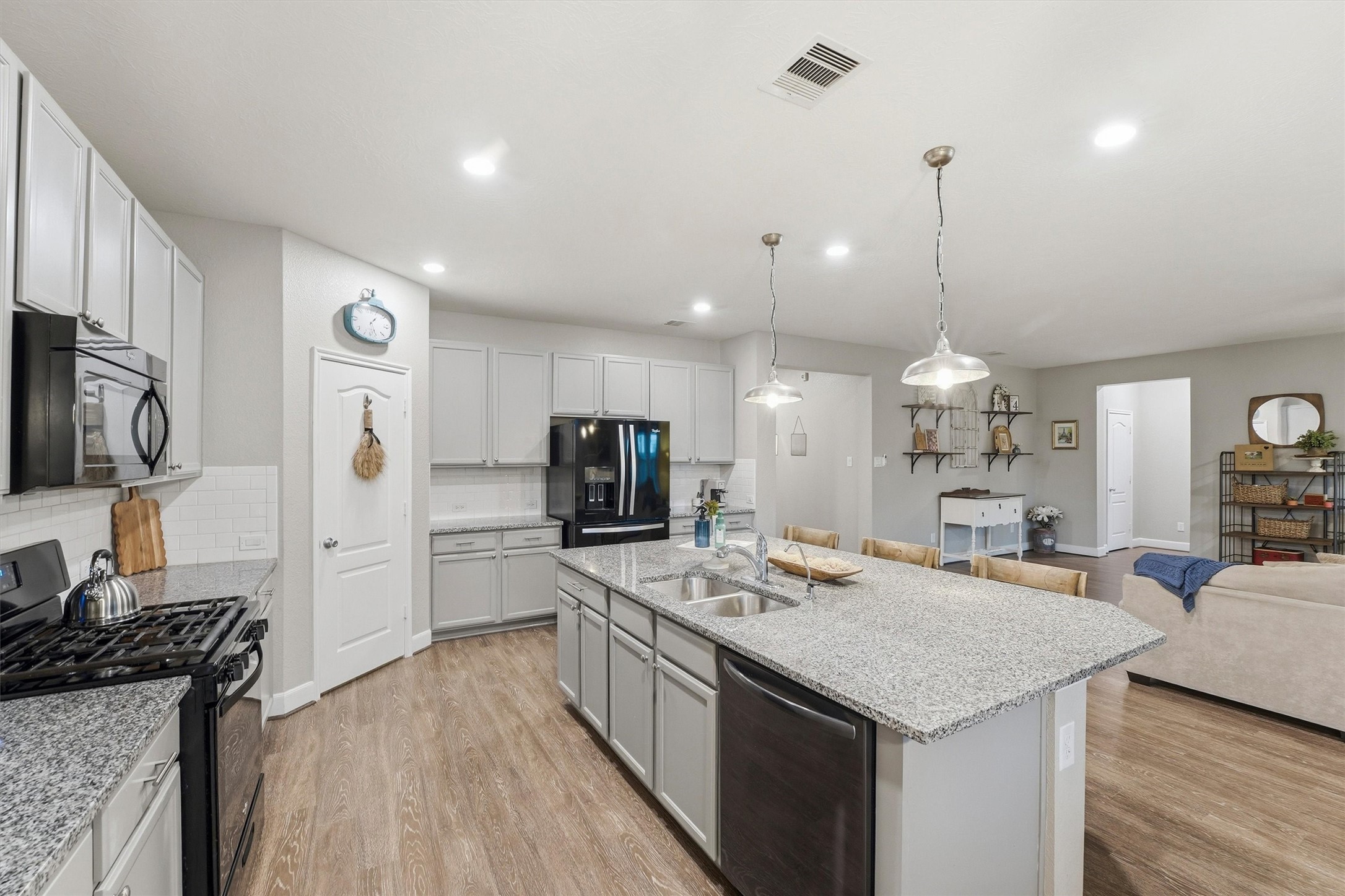 Kitchen view with walk-in corner pantry that has ample storage.