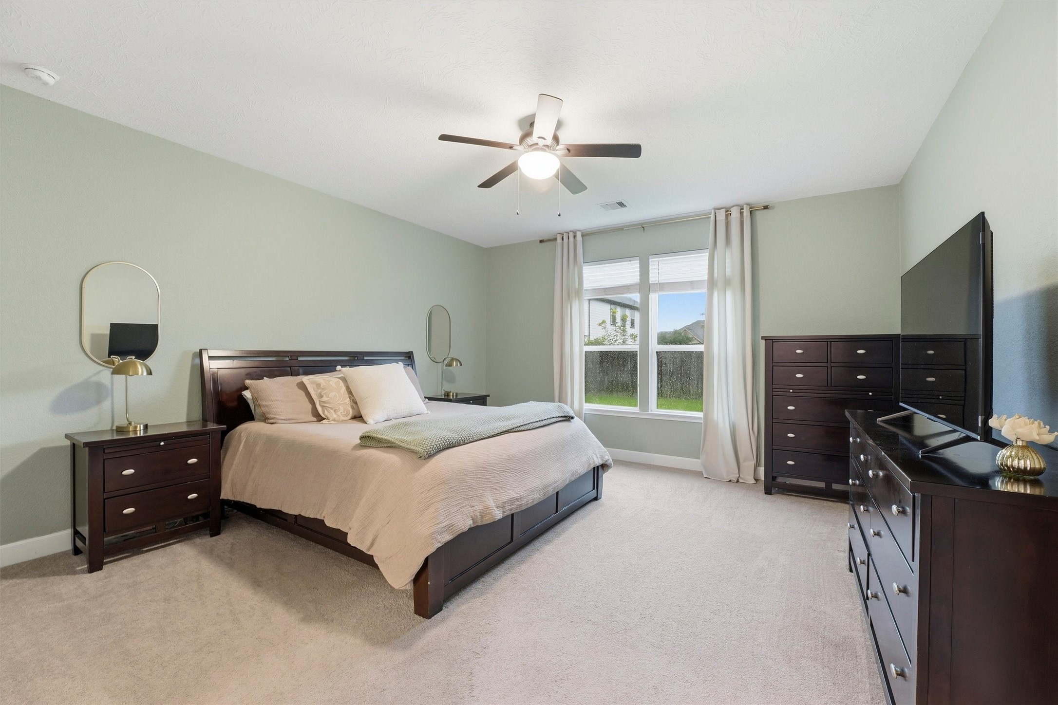 Light-filled primary bedroom offering a comfortable layout and generous room for furnishings.