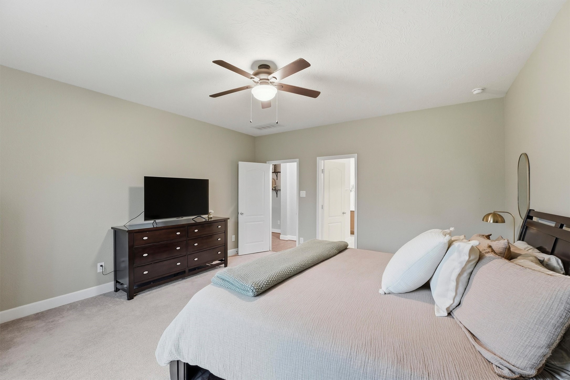 Another perspective of the primary suite highlighting the expansive floor space and retreat-like atmosphere.