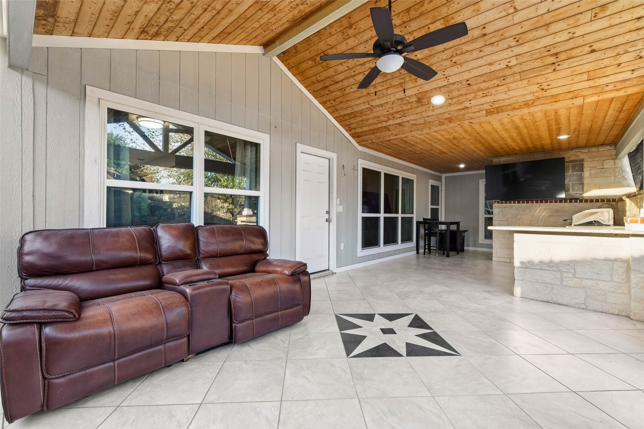 Spacious covered patio with outdoor kitchen. Great space for outdoor living and entertaining.