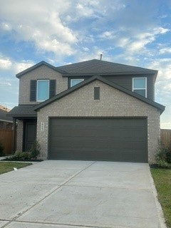 Charming two-story home with a modern brick exterior and spacious two-car garage, set on a well-maintained driveway.