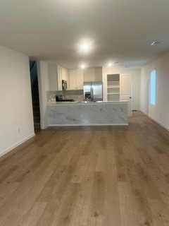 Spacious open-concept living area with hardwood floor on the first floor