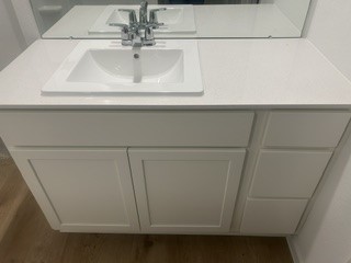 Sleek bathroom vanity with a modern sink and ample storage space.