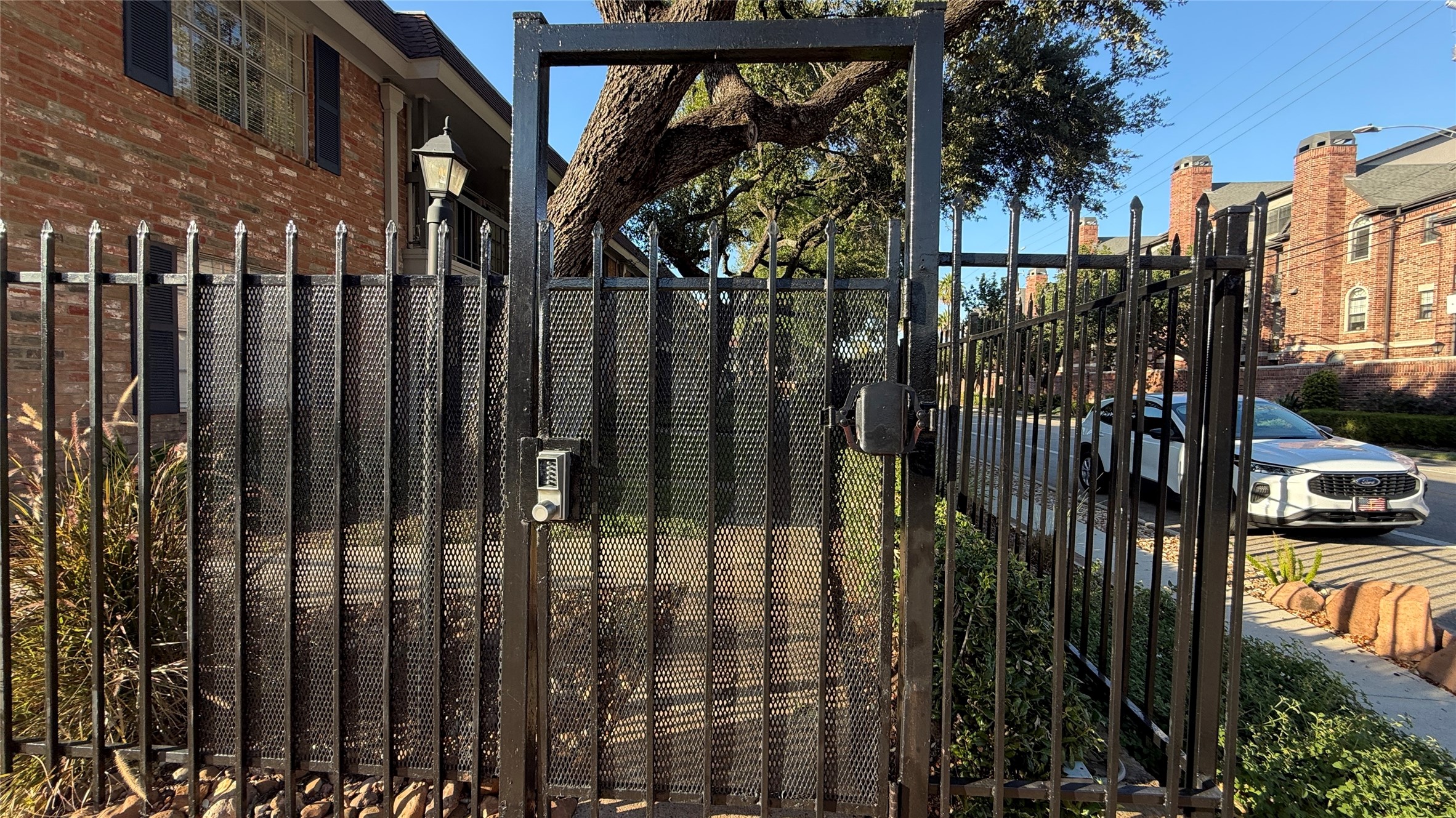 Controlled-access pedestrian gate offers convenient entry to the landscaped condominium community.