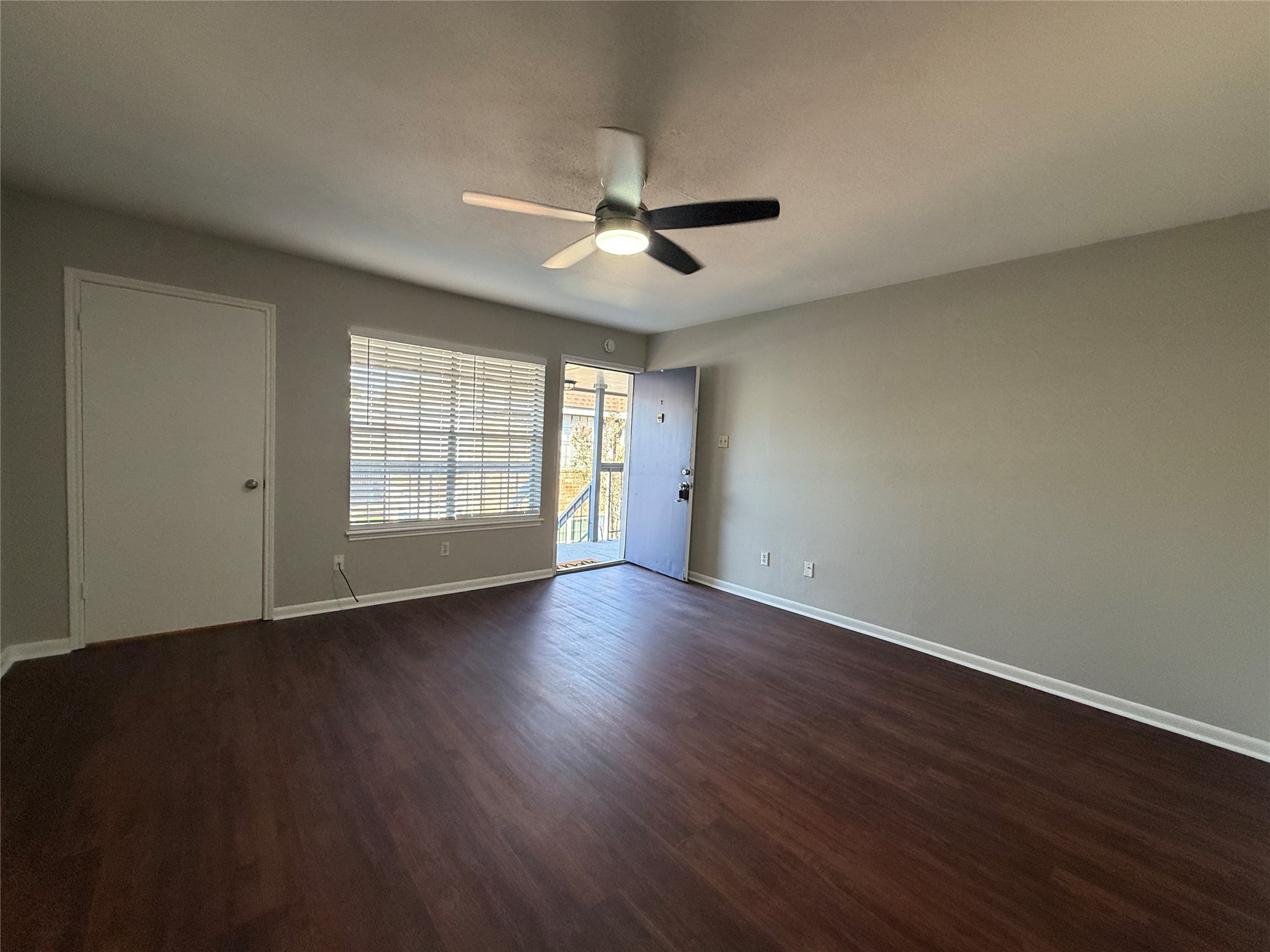 Inviting living area featuring vinyl plank flooring, neutral paint tones, and natural light.